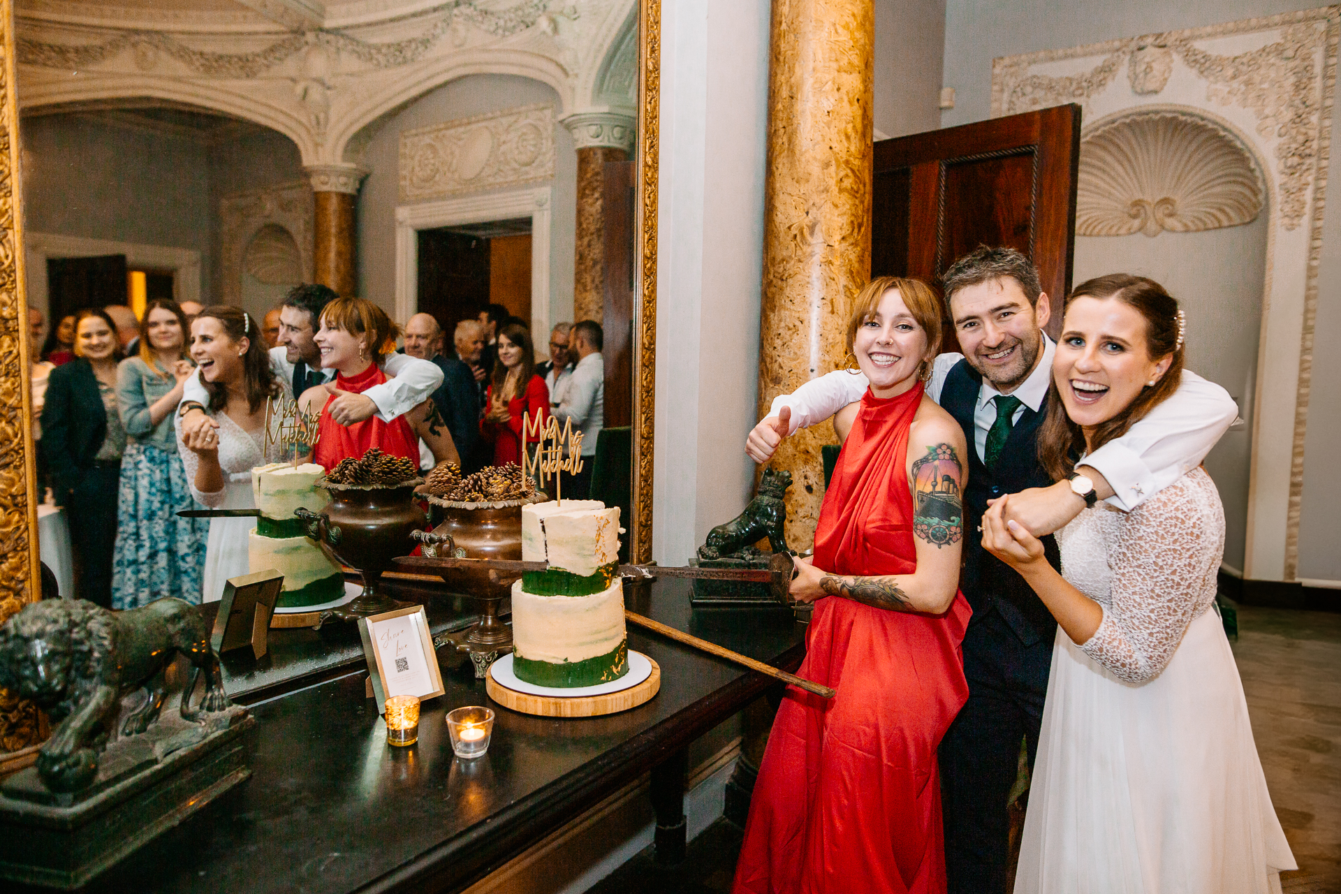 A group of people standing around a cake