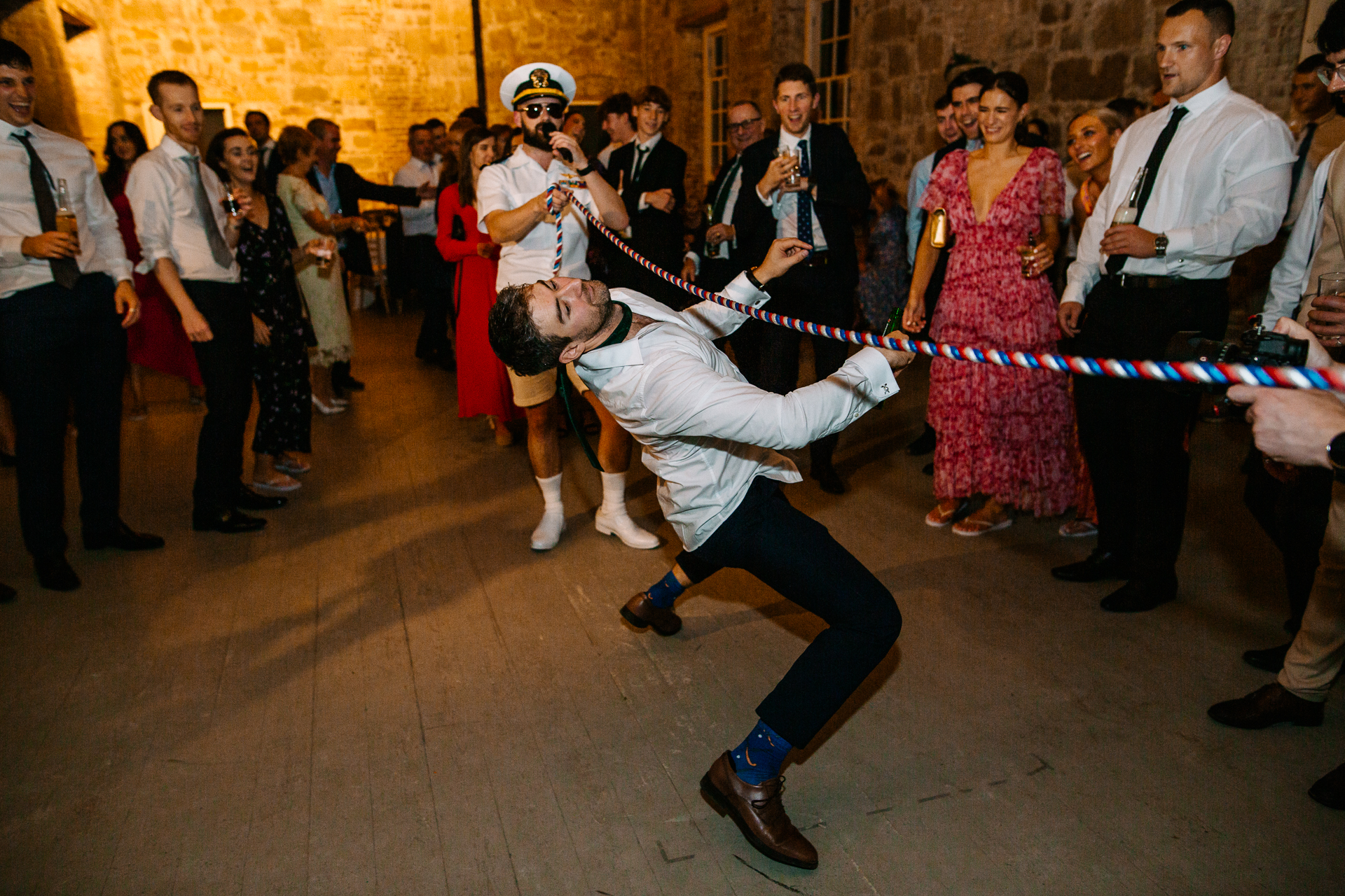 A person in a white suit dancing in front of a crowd