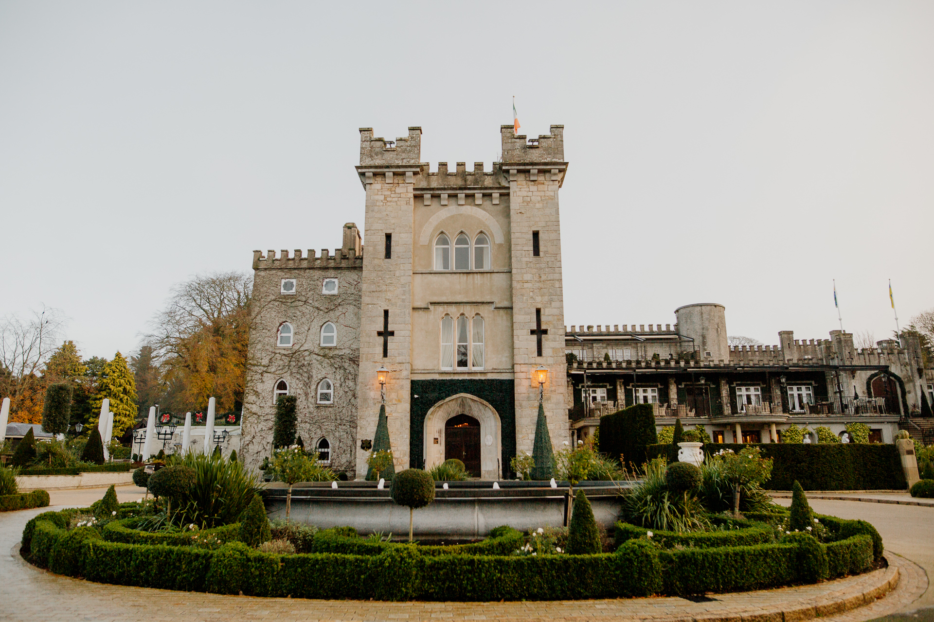 A large stone building with a garden in front of it