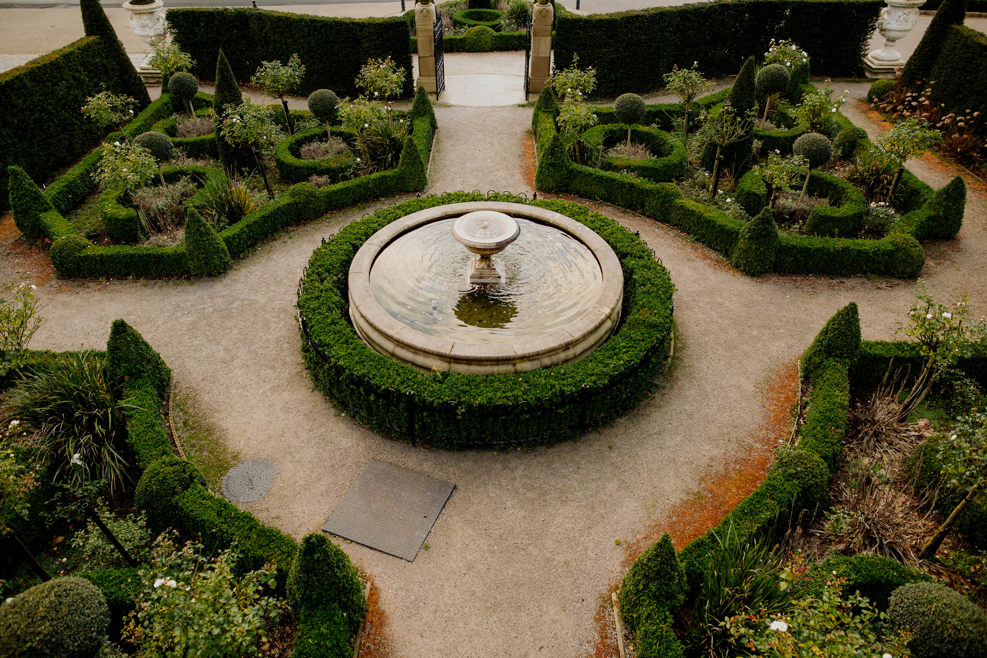 A large circular structure surrounded by bushes