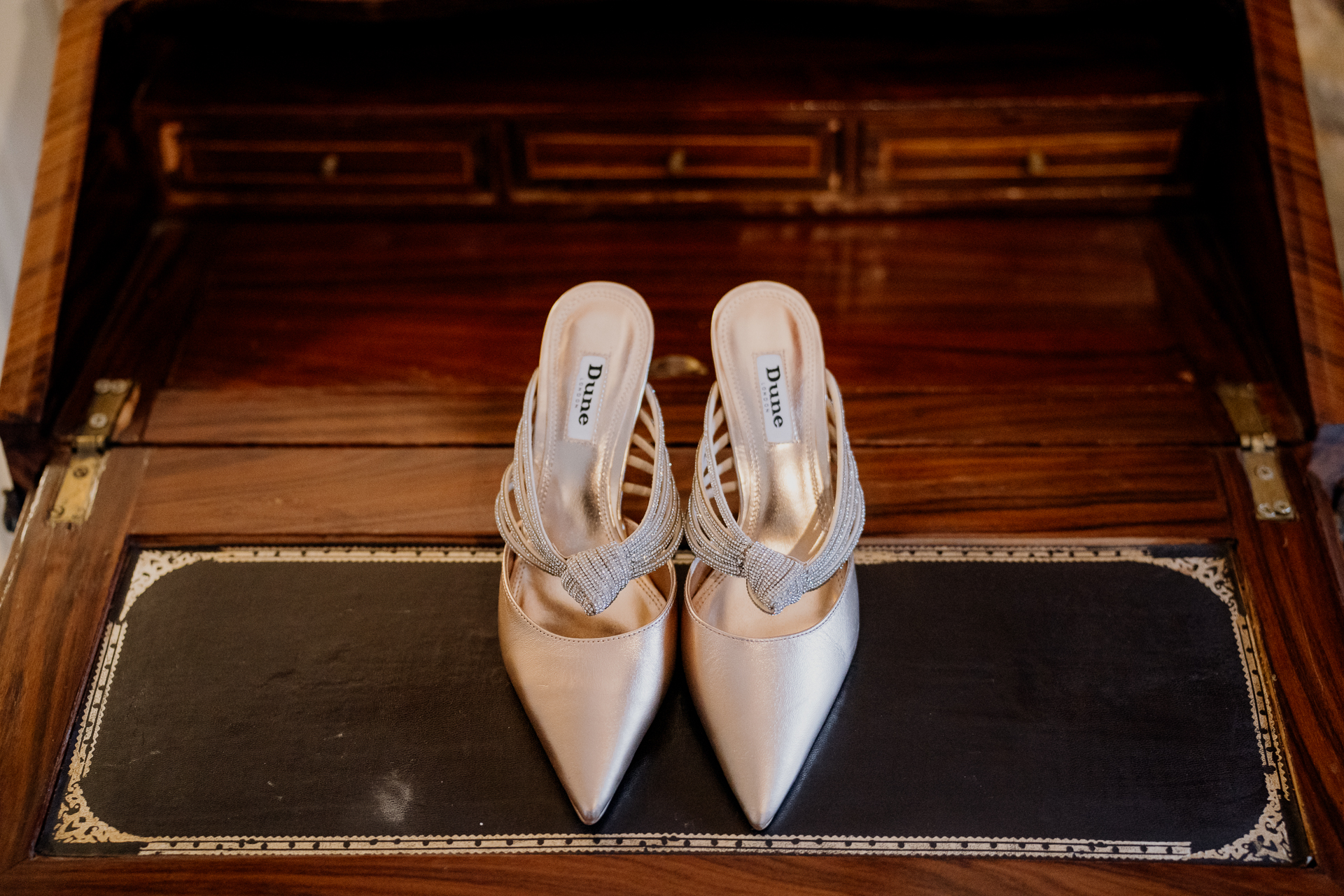 A pair of white shoes on a black mat