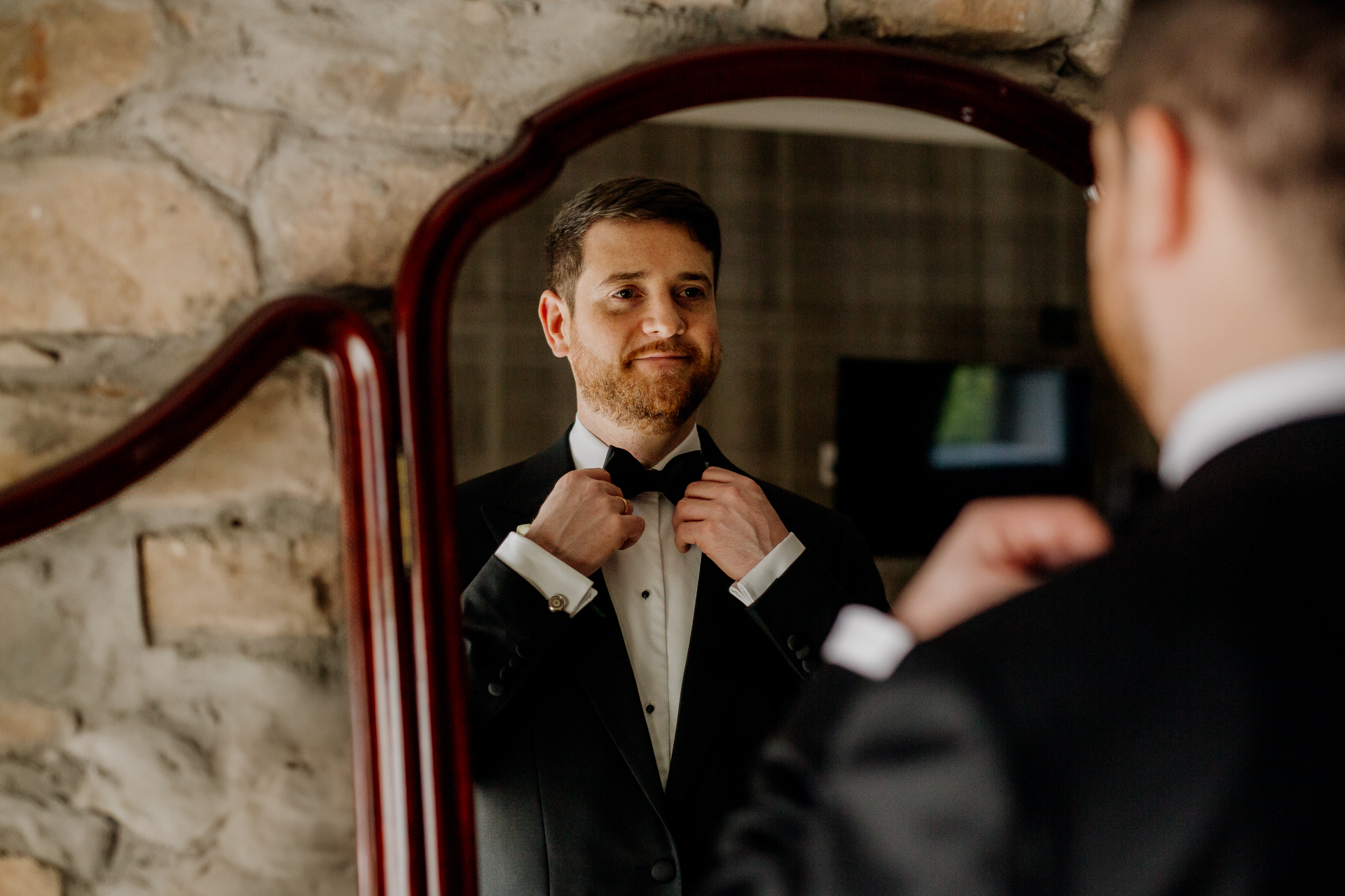 A man adjusting his bow tie