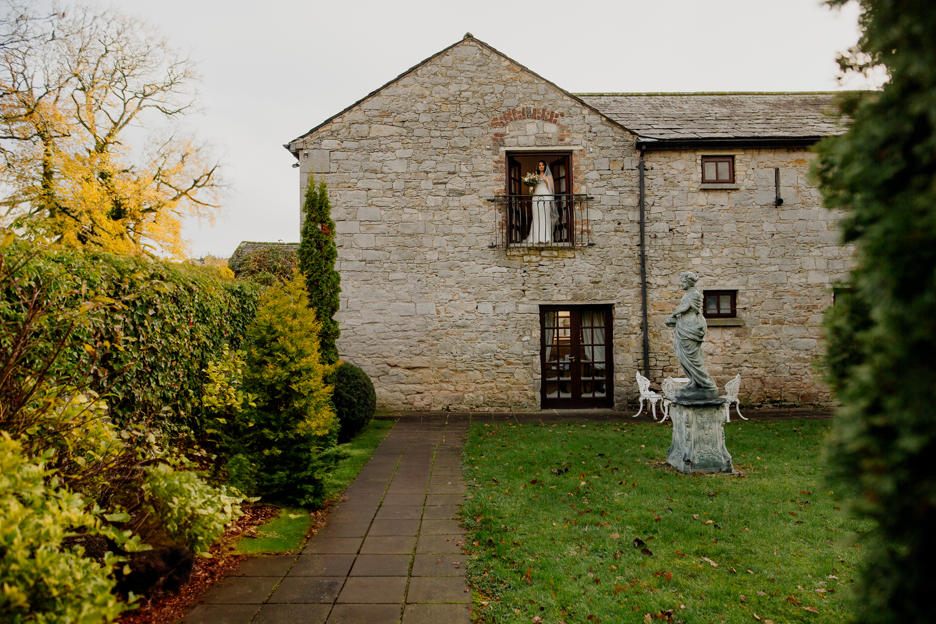 A stone building with a statue in front of it