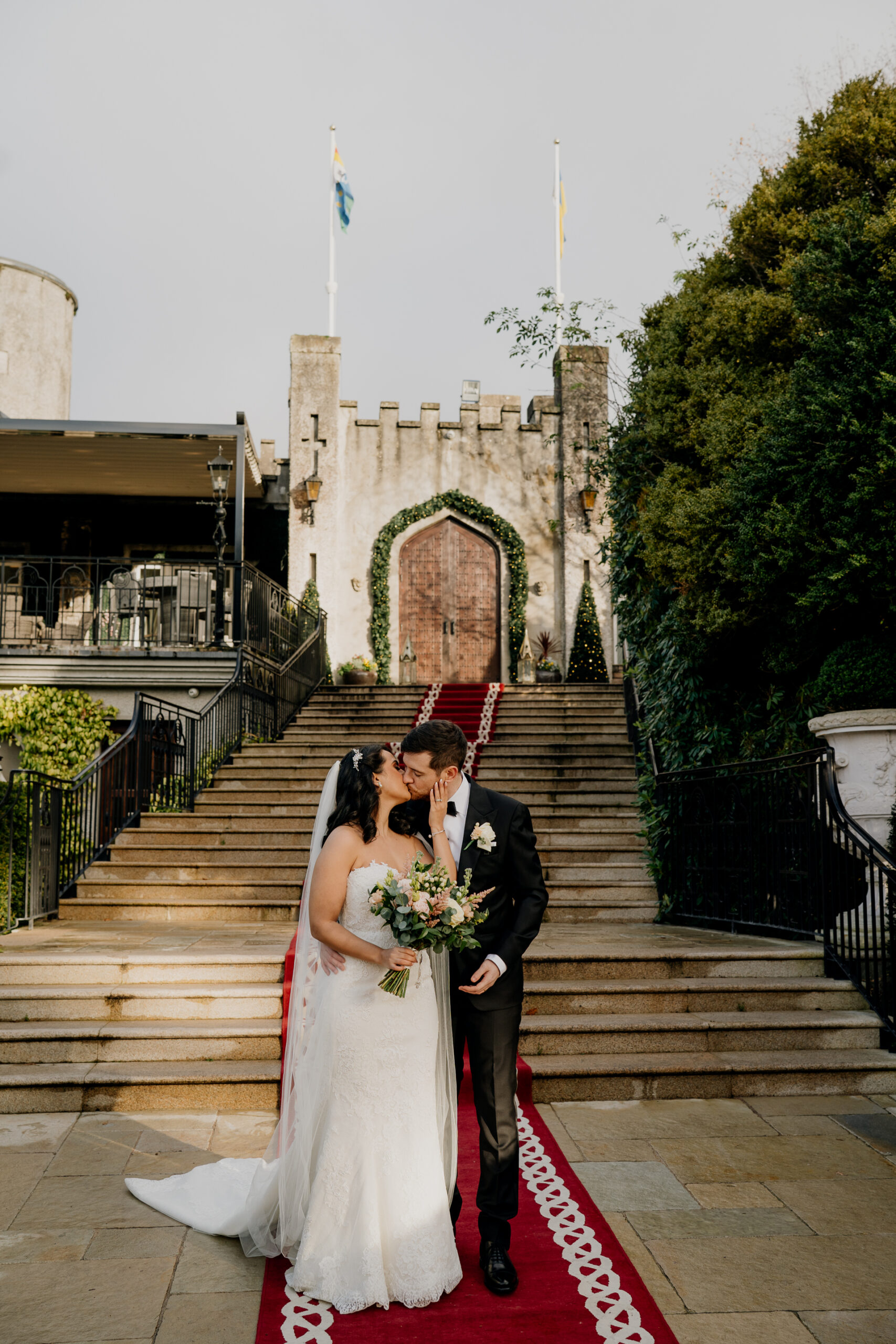 A man and woman kissing on stairs