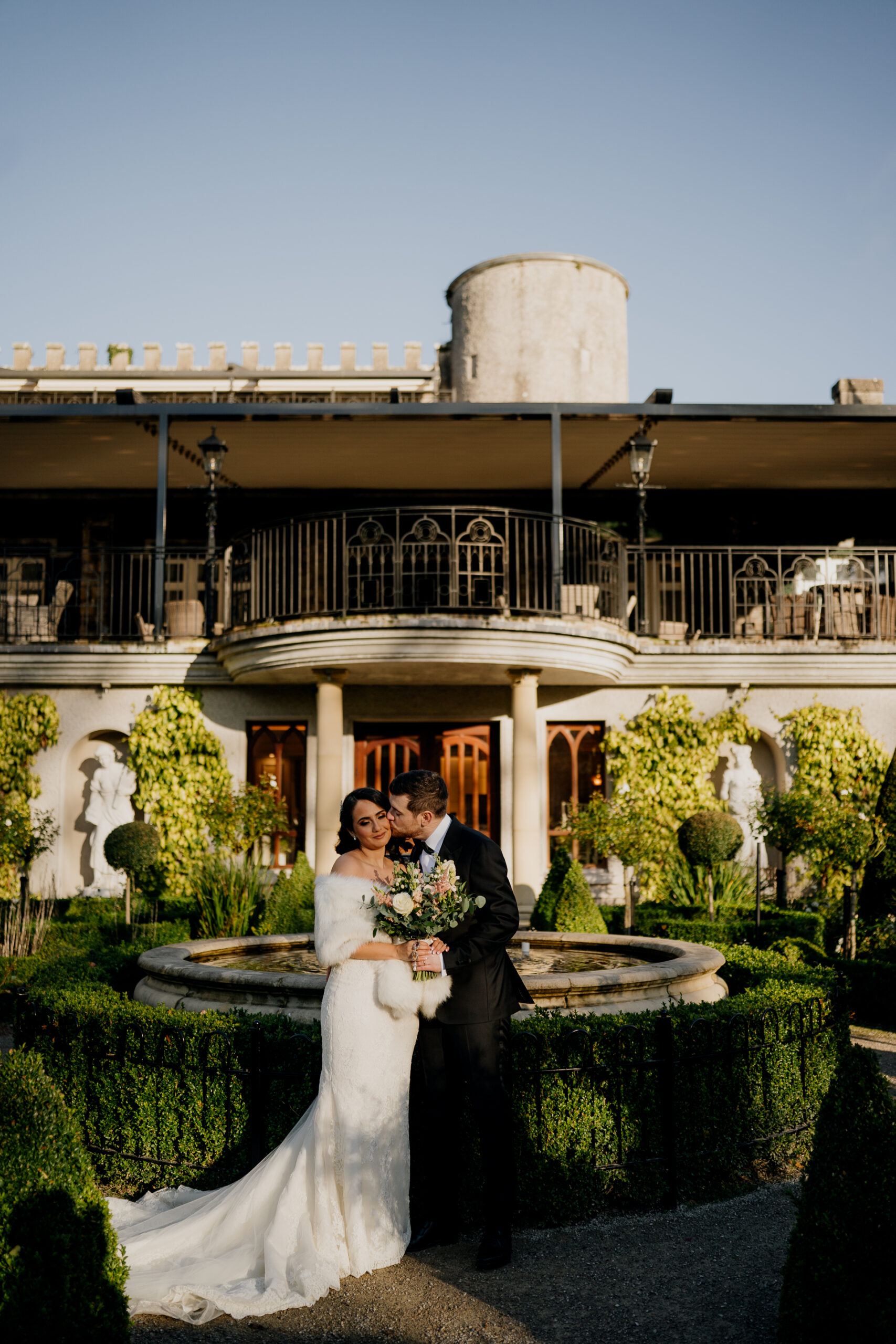 A man and woman posing for a picture in front of a building