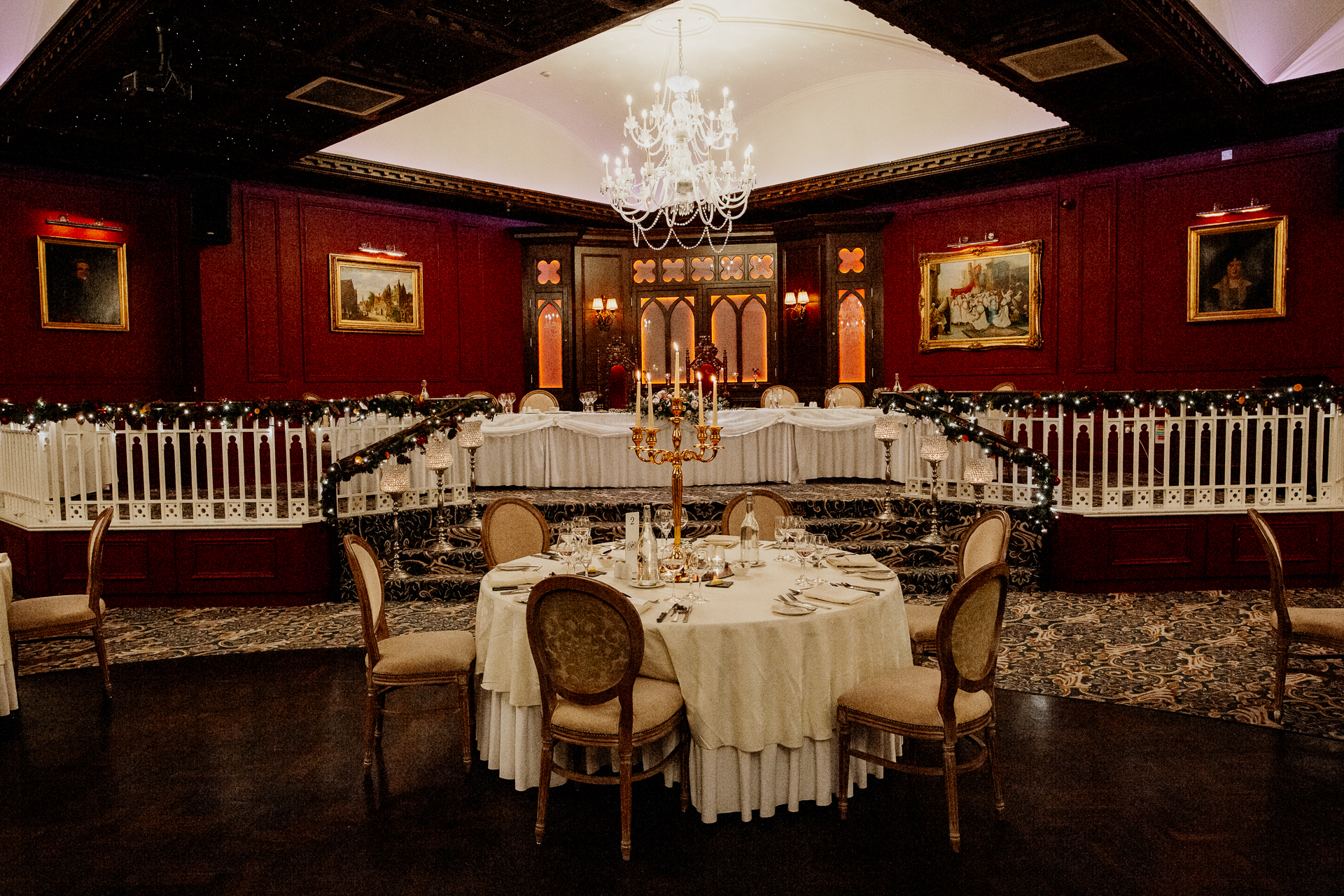 A dining room with a chandelier and a table set