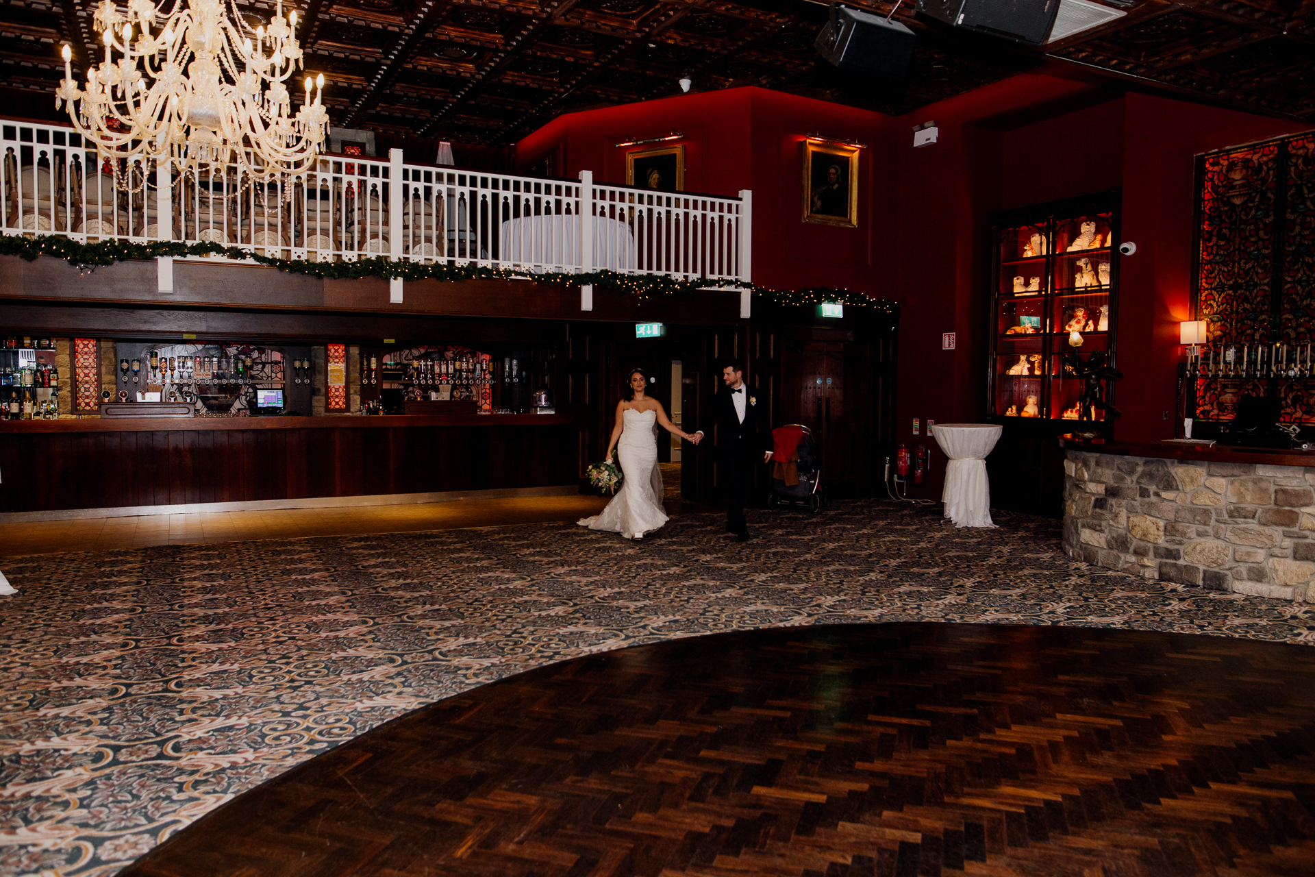 A bride and groom walking down a hall