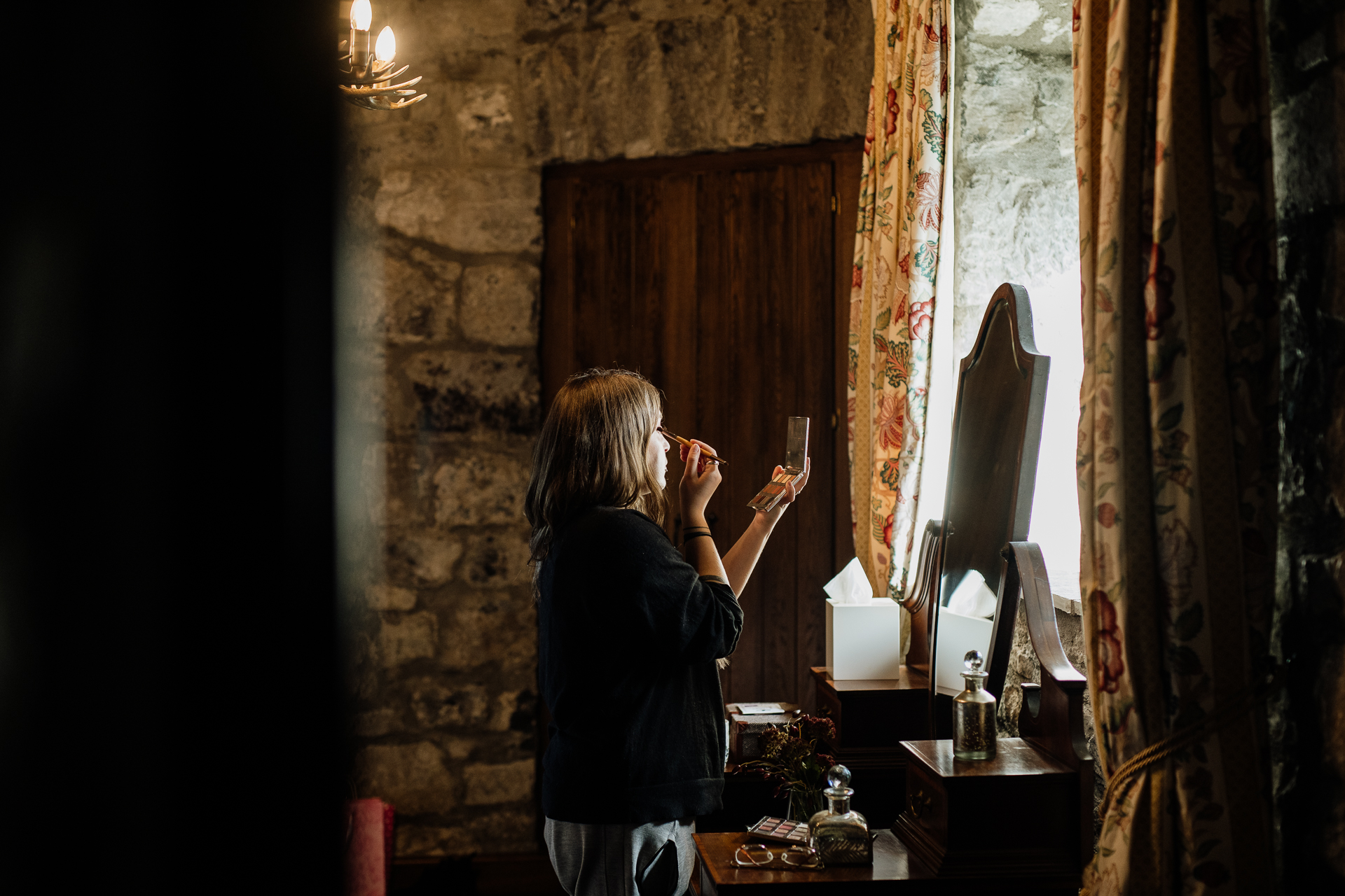 A person taking a picture of a painting in a room