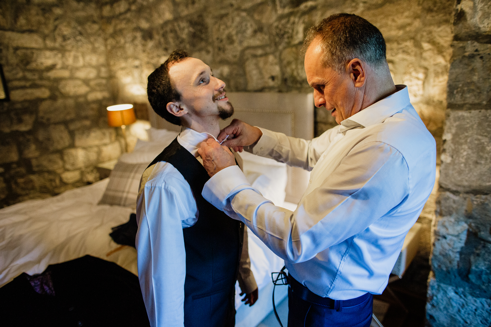 A man putting on a tie