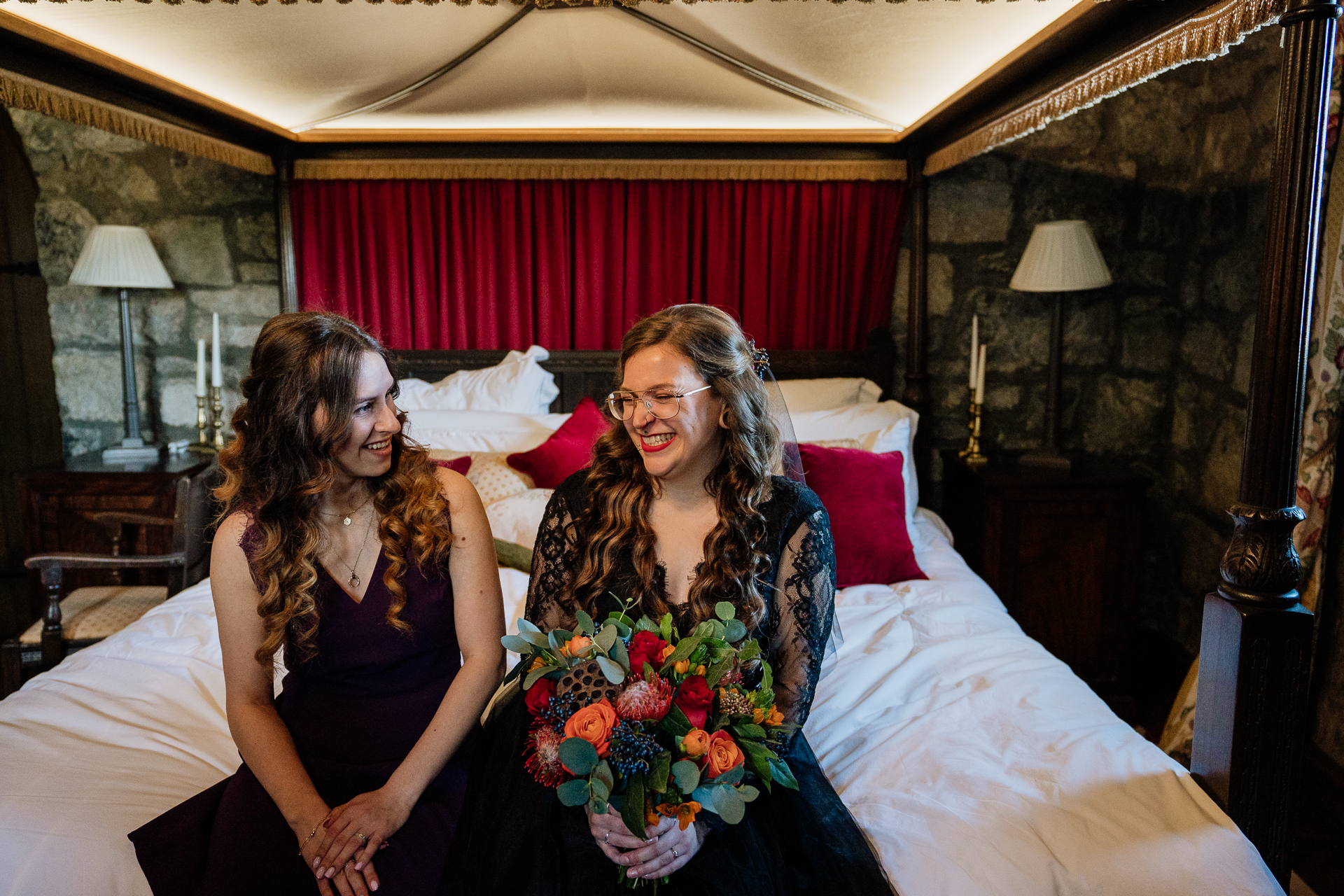 Two women sitting on a bed