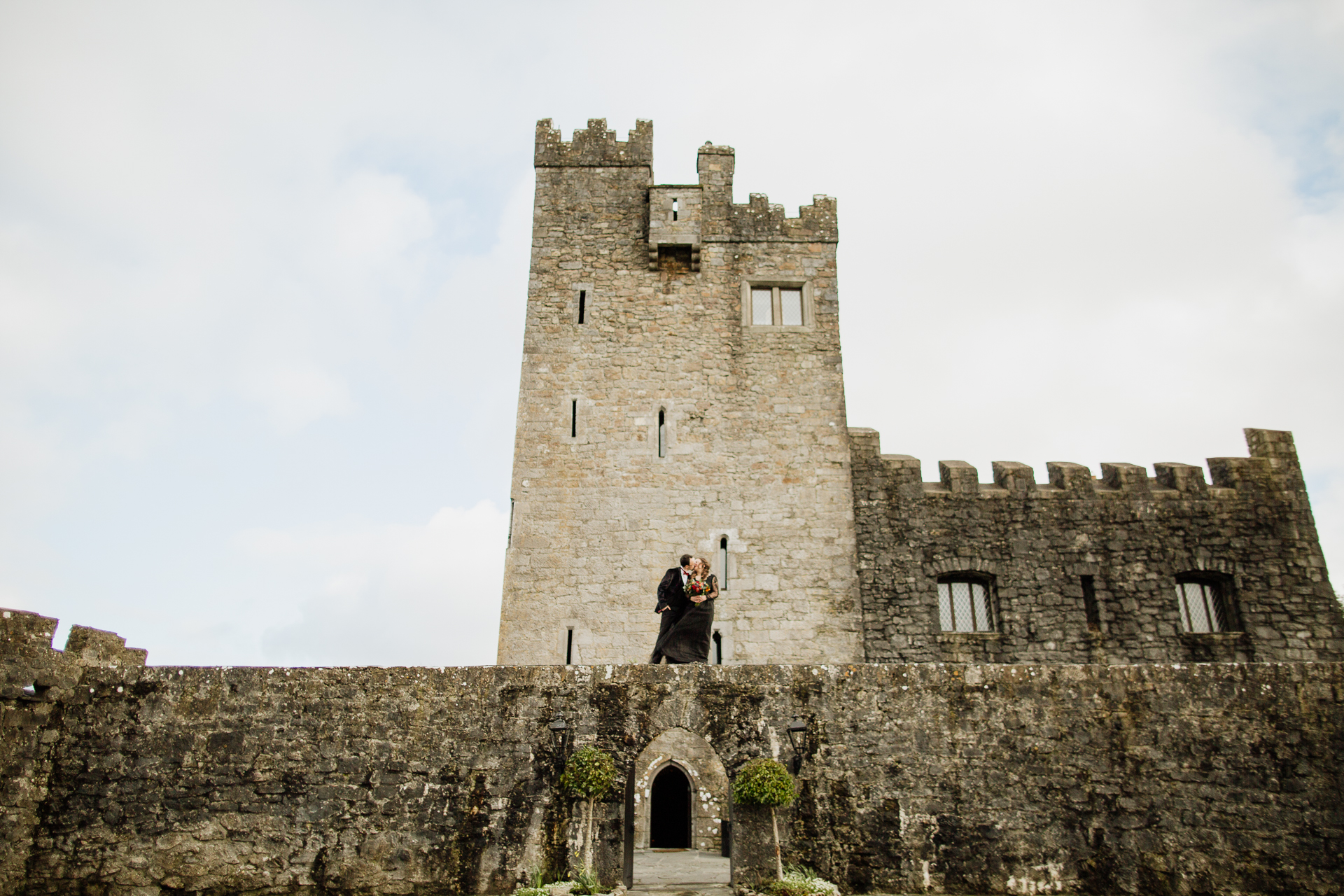 A group of people standing in front of a castle