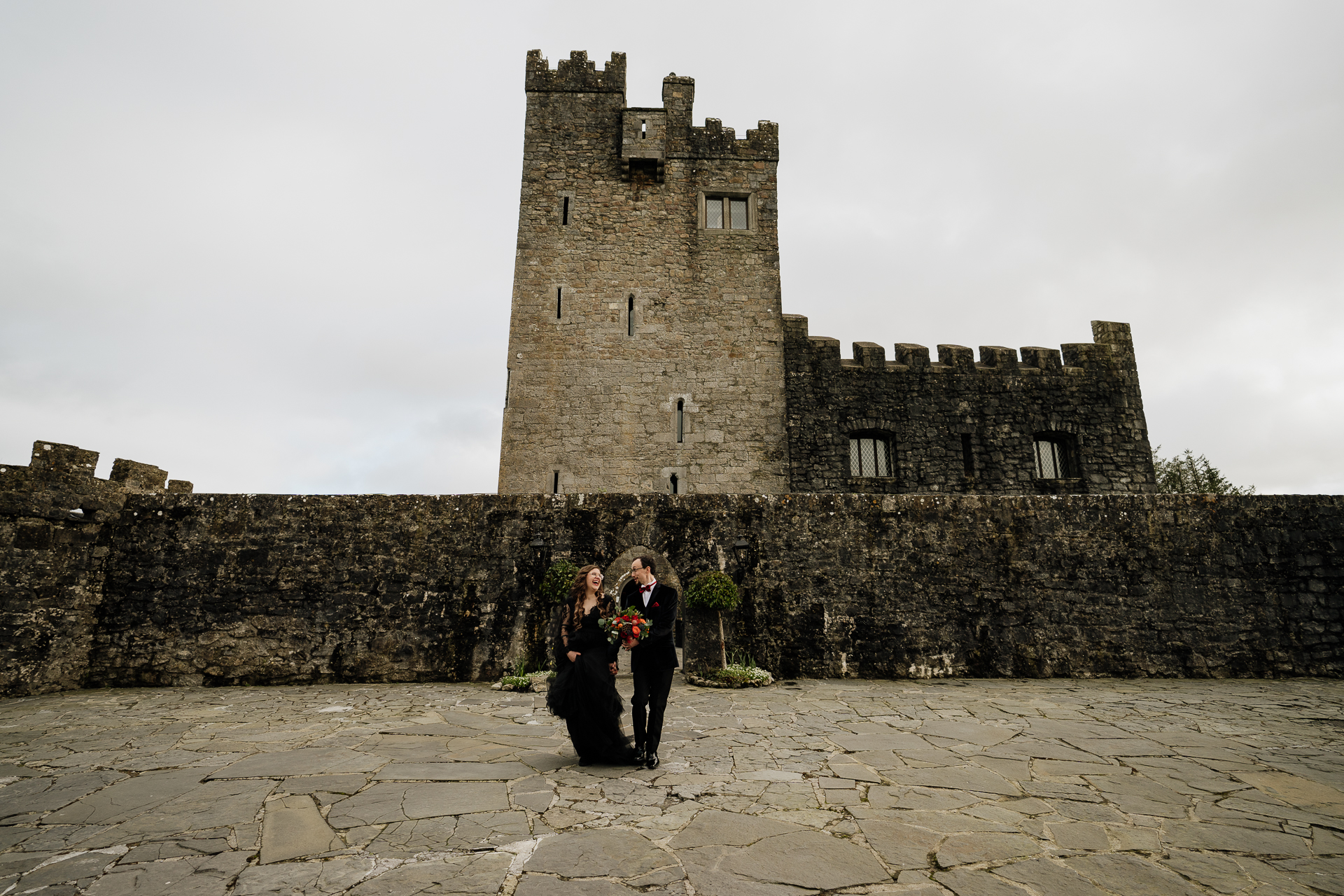 A group of people standing in front of a castle