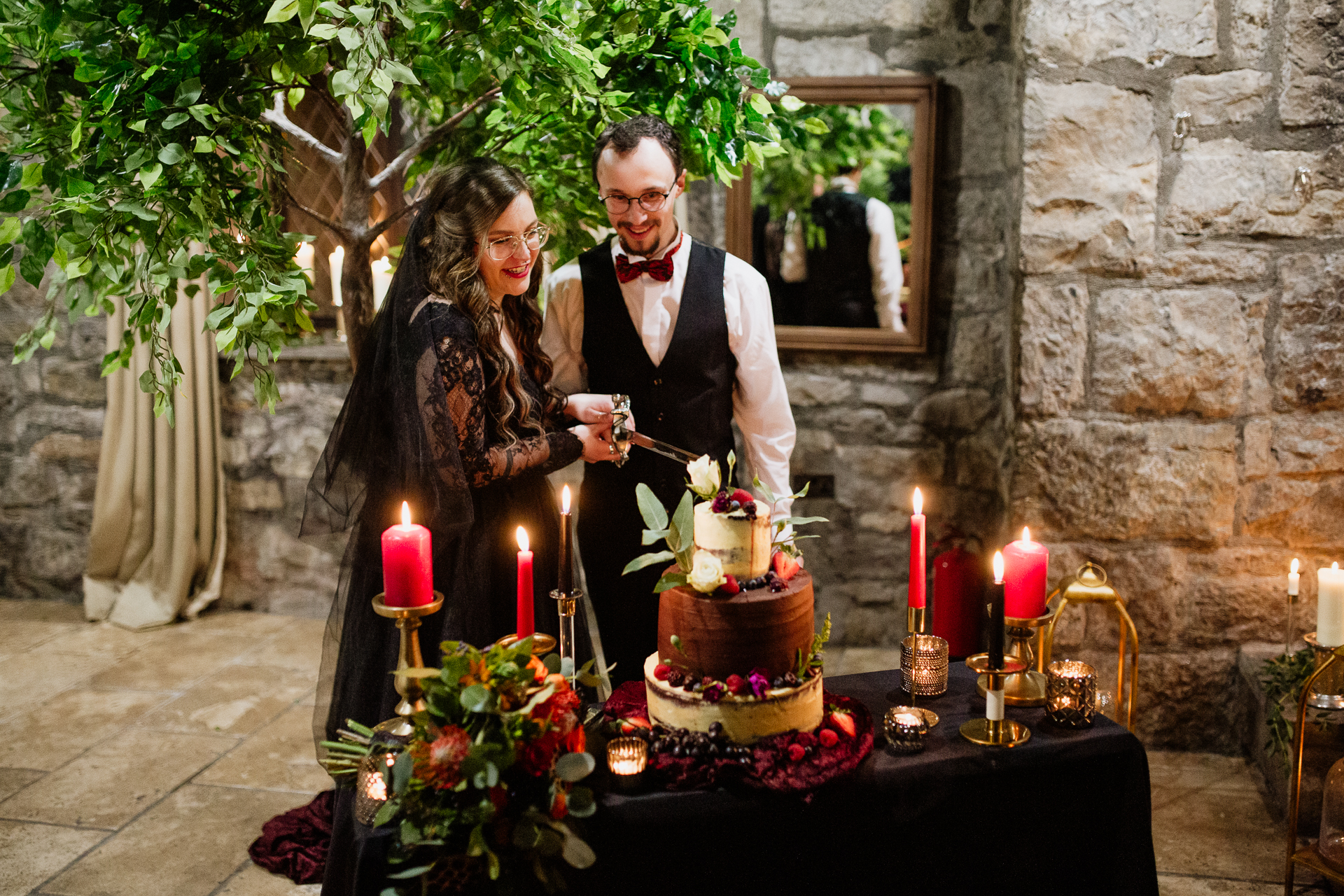 A man and woman cutting a cake