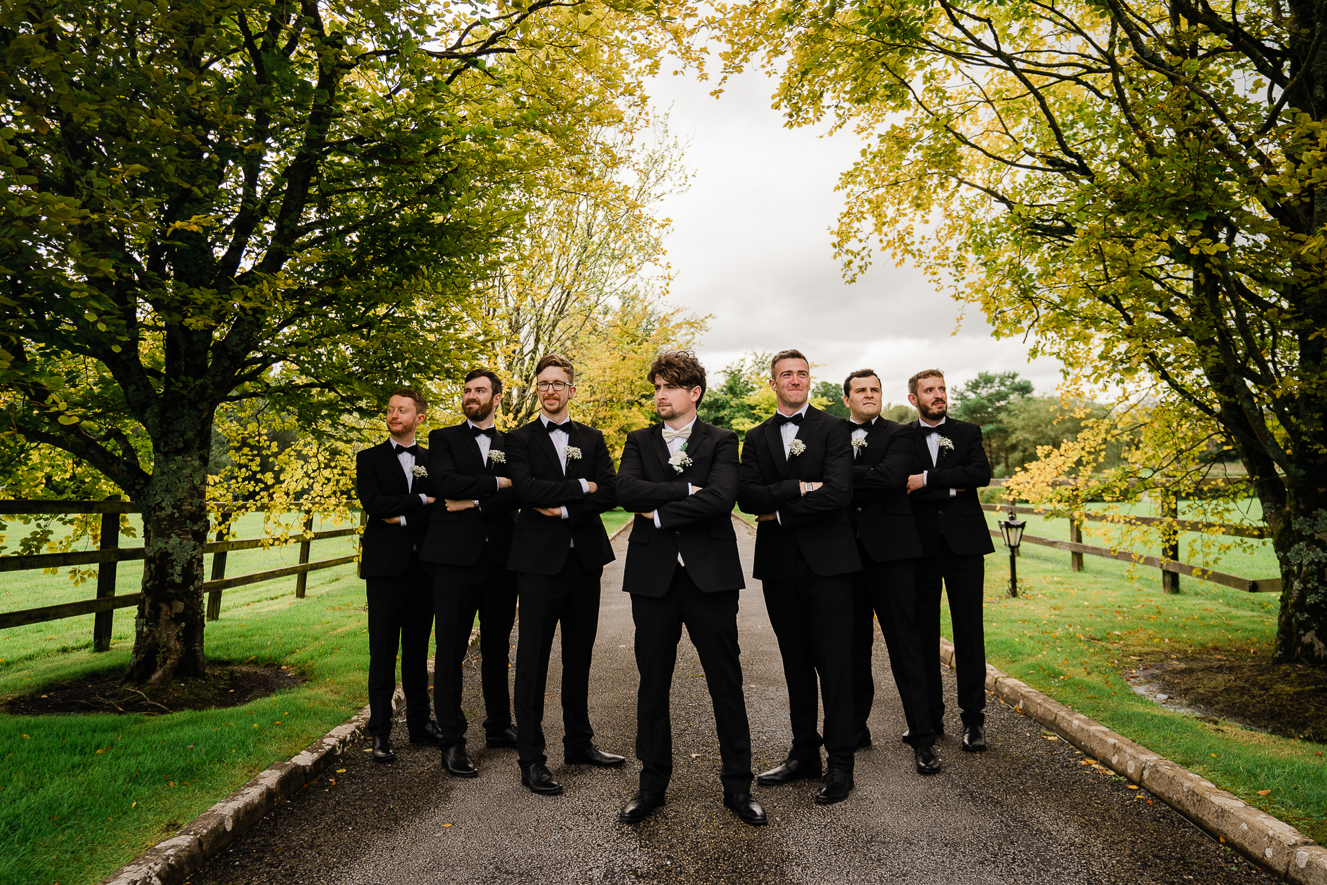 A group of men in suits standing on a path