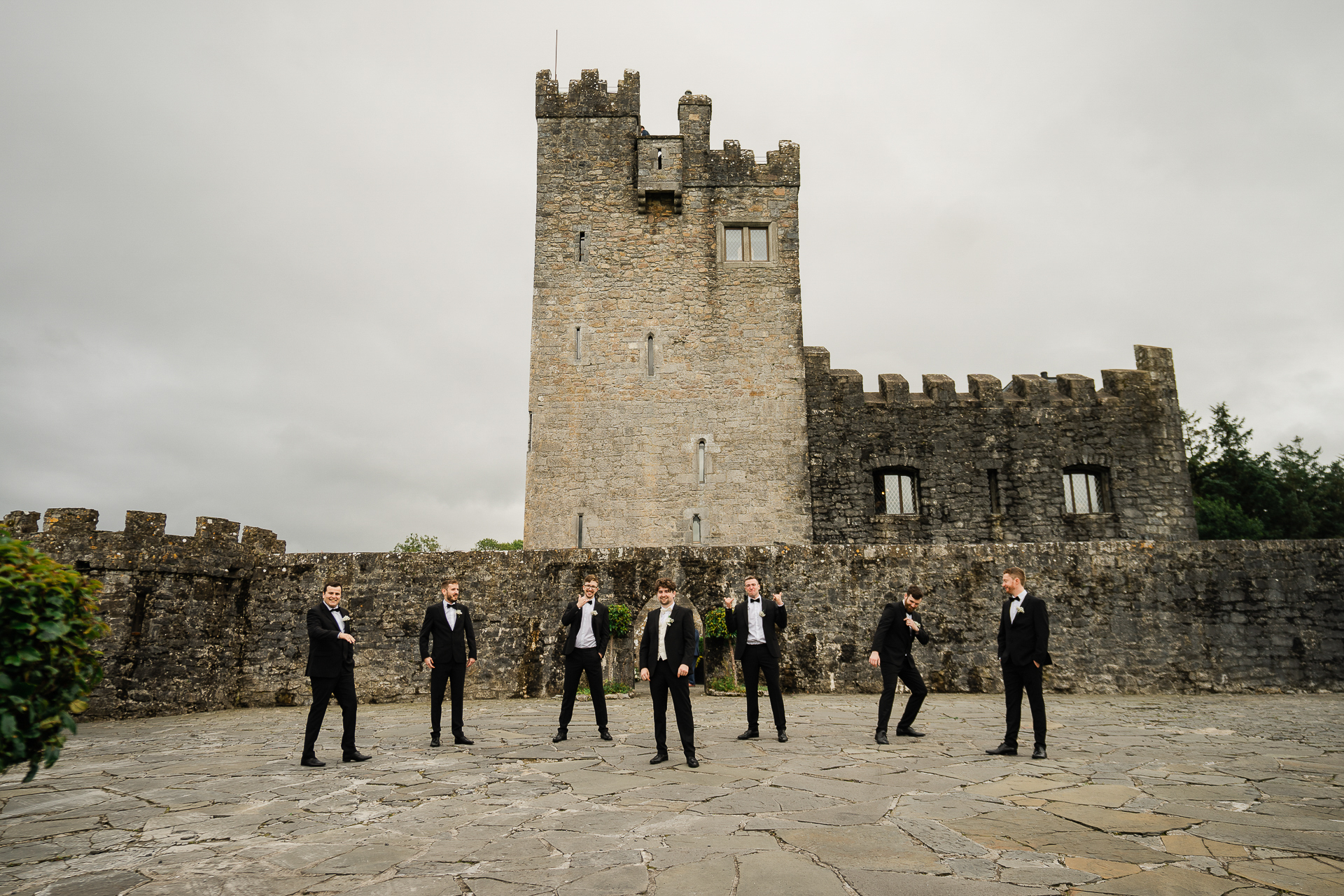 A group of people standing in front of a castle