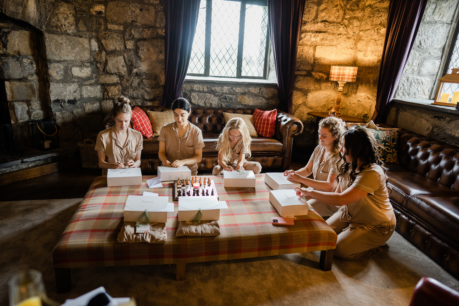 A group of people sitting around a table with food on it