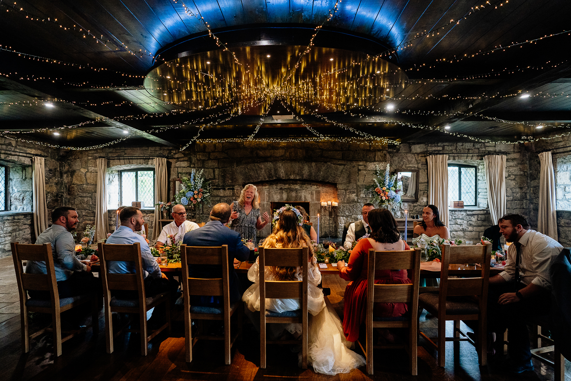 A group of people sitting in a room with chandeliers