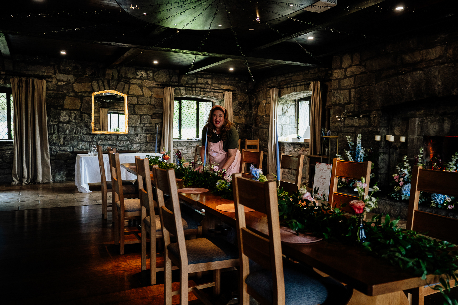 A person standing in a room with chairs and tables