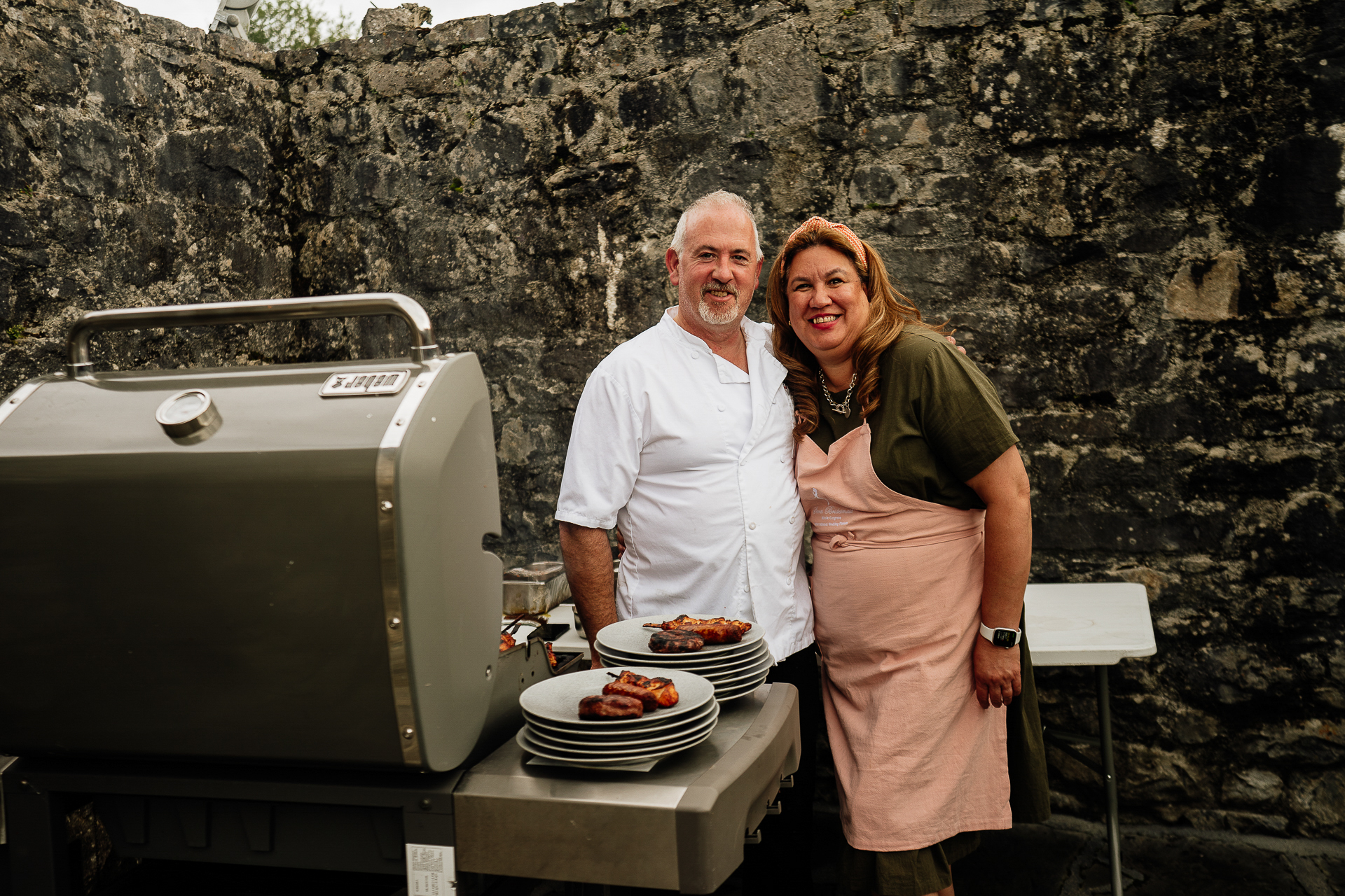 A couple stands next to a toaster oven