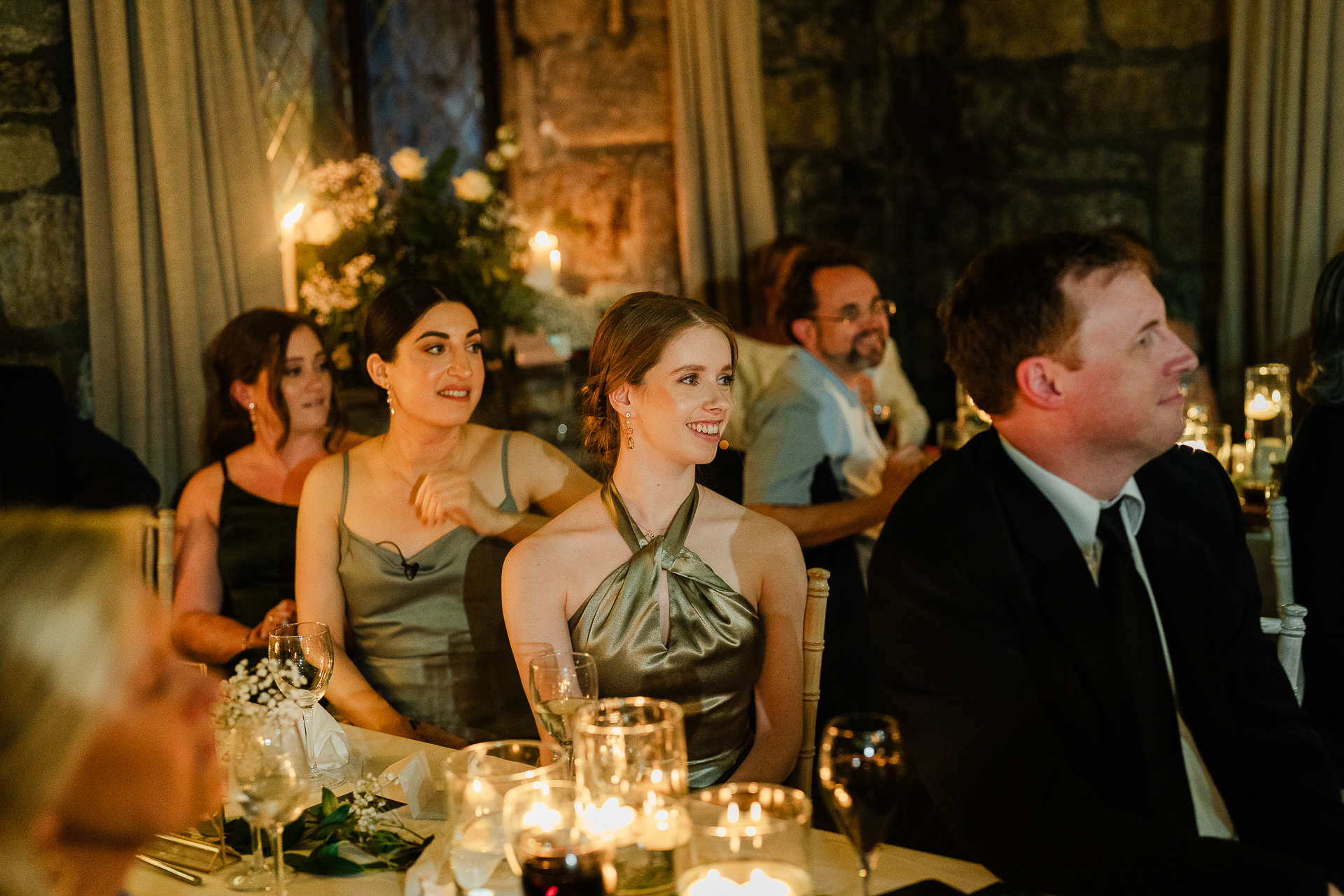 A group of people sitting at a table with wine glasses