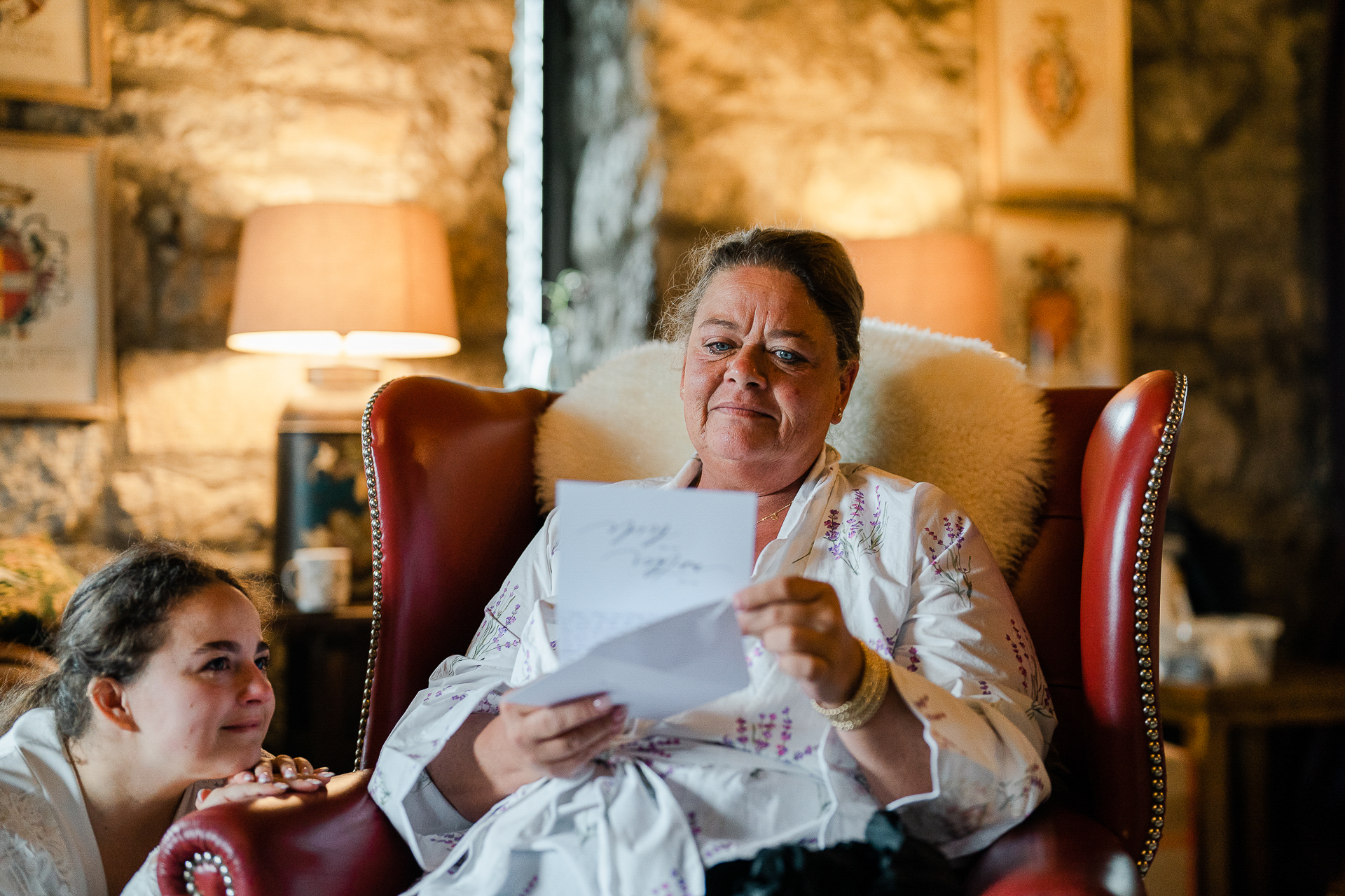 A man sitting in a chair reading a paper