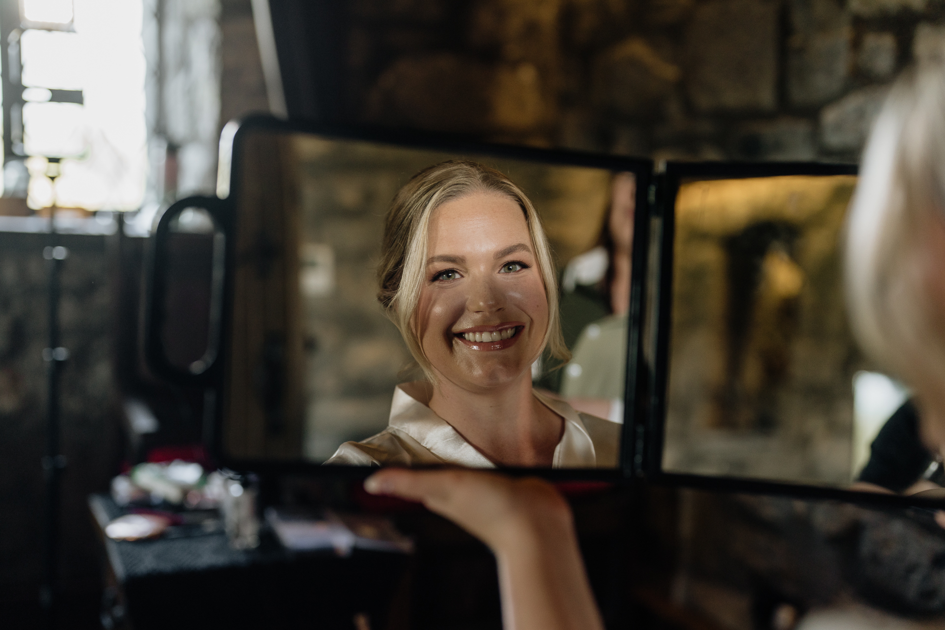 A person smiling in a mirror