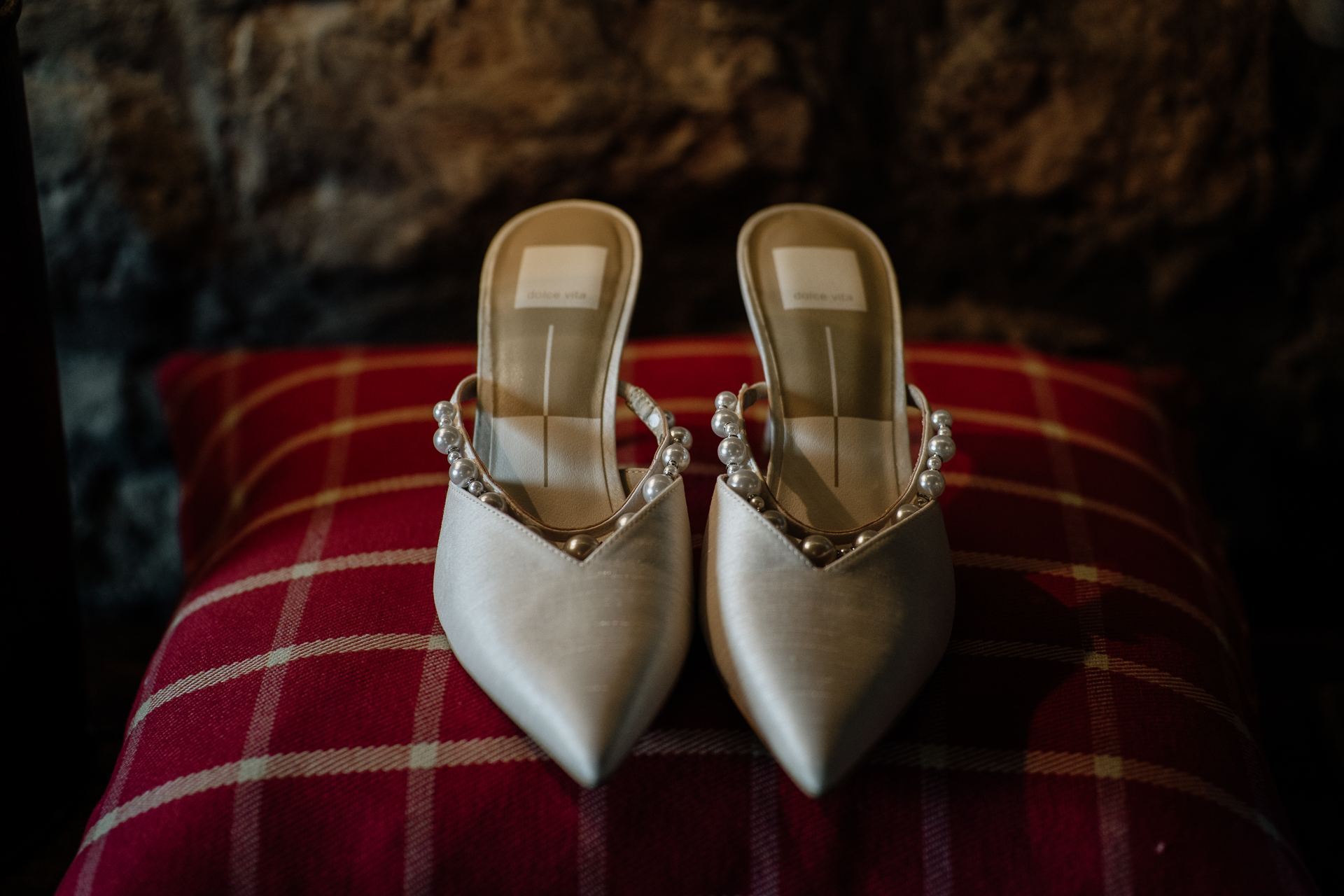 A pair of shoes on a red and white striped blanket