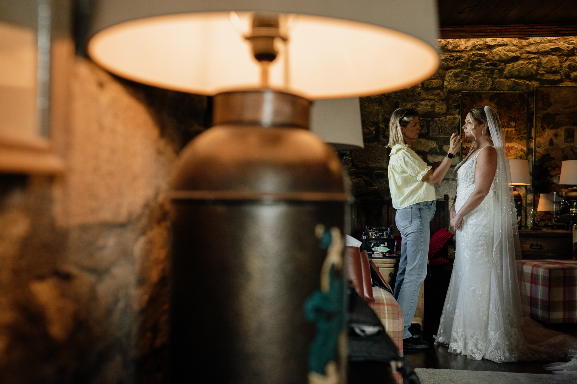 A bride and groom standing next to a large metal barrel