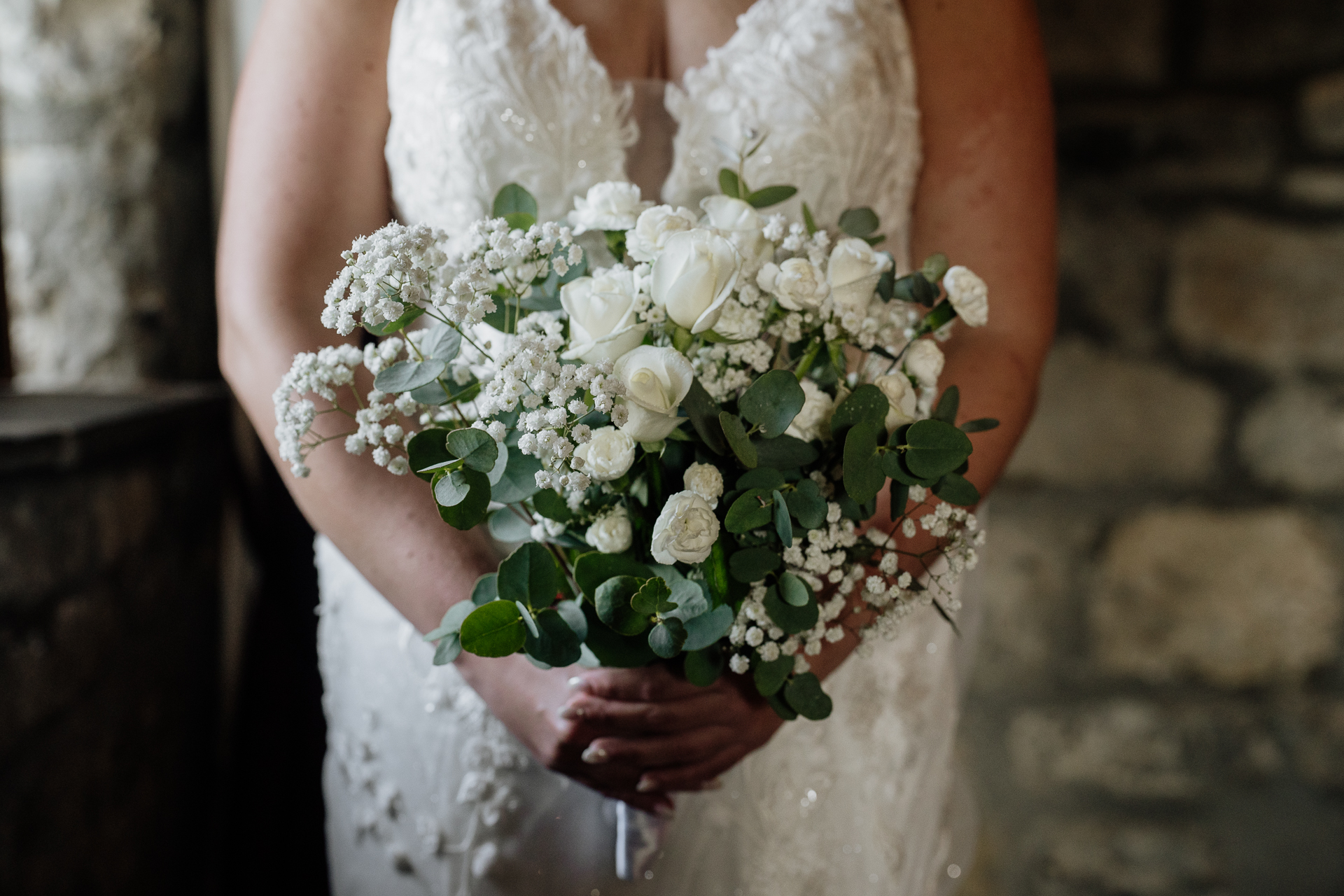 A person holding a bouquet of white flowers