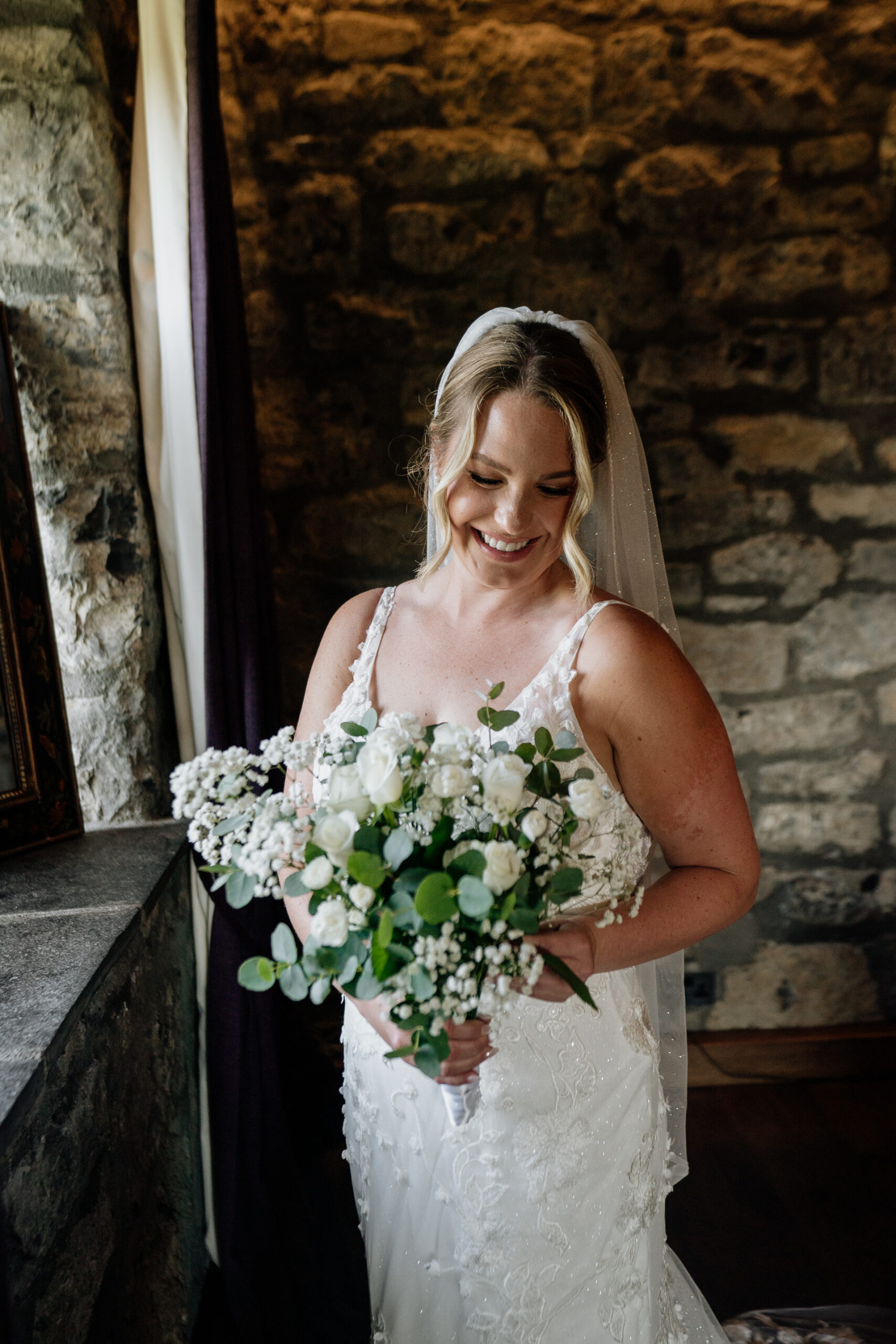 A woman in a white dress holding a bouquet of flowers