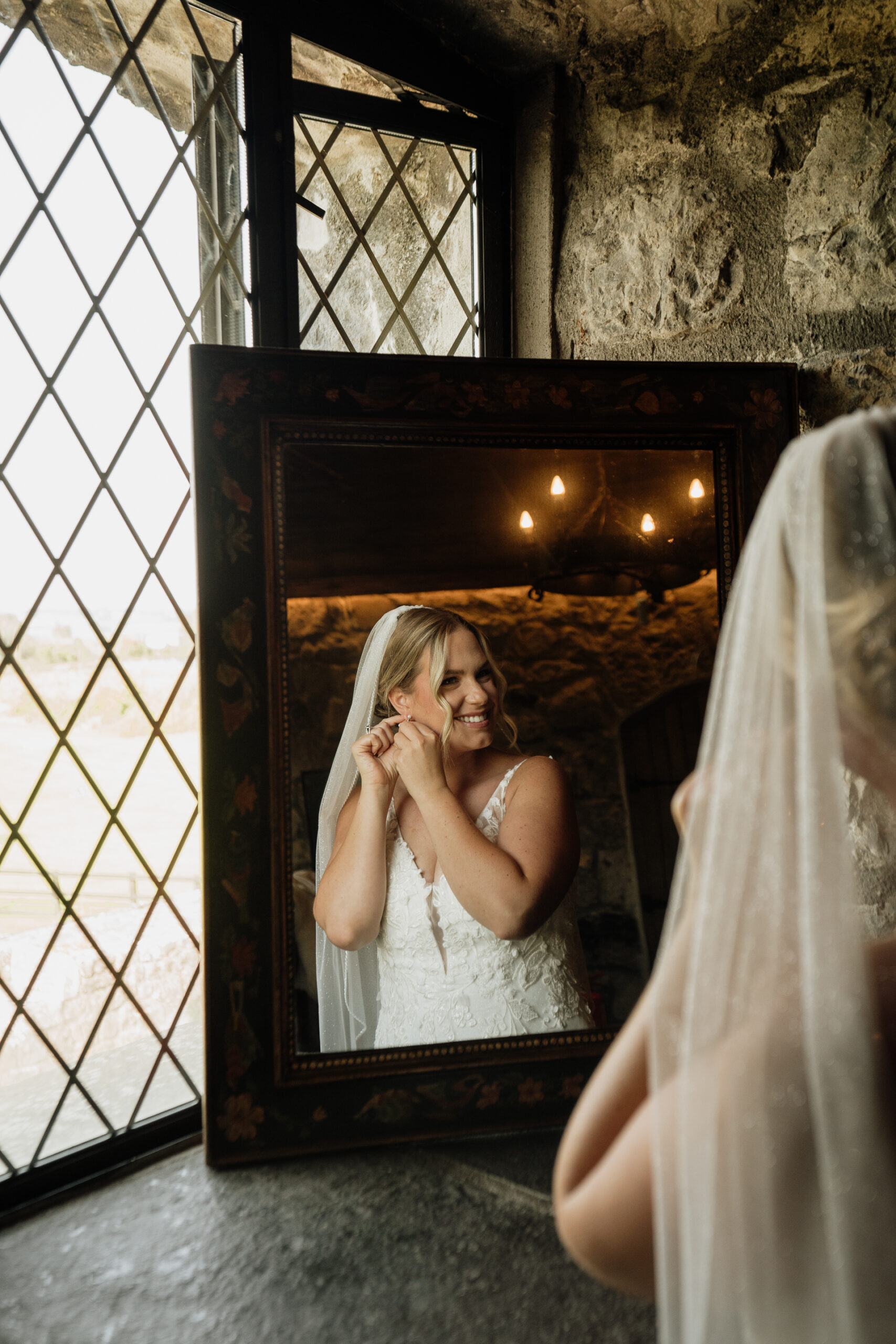 A person in a white dress taking a selfie in a mirror