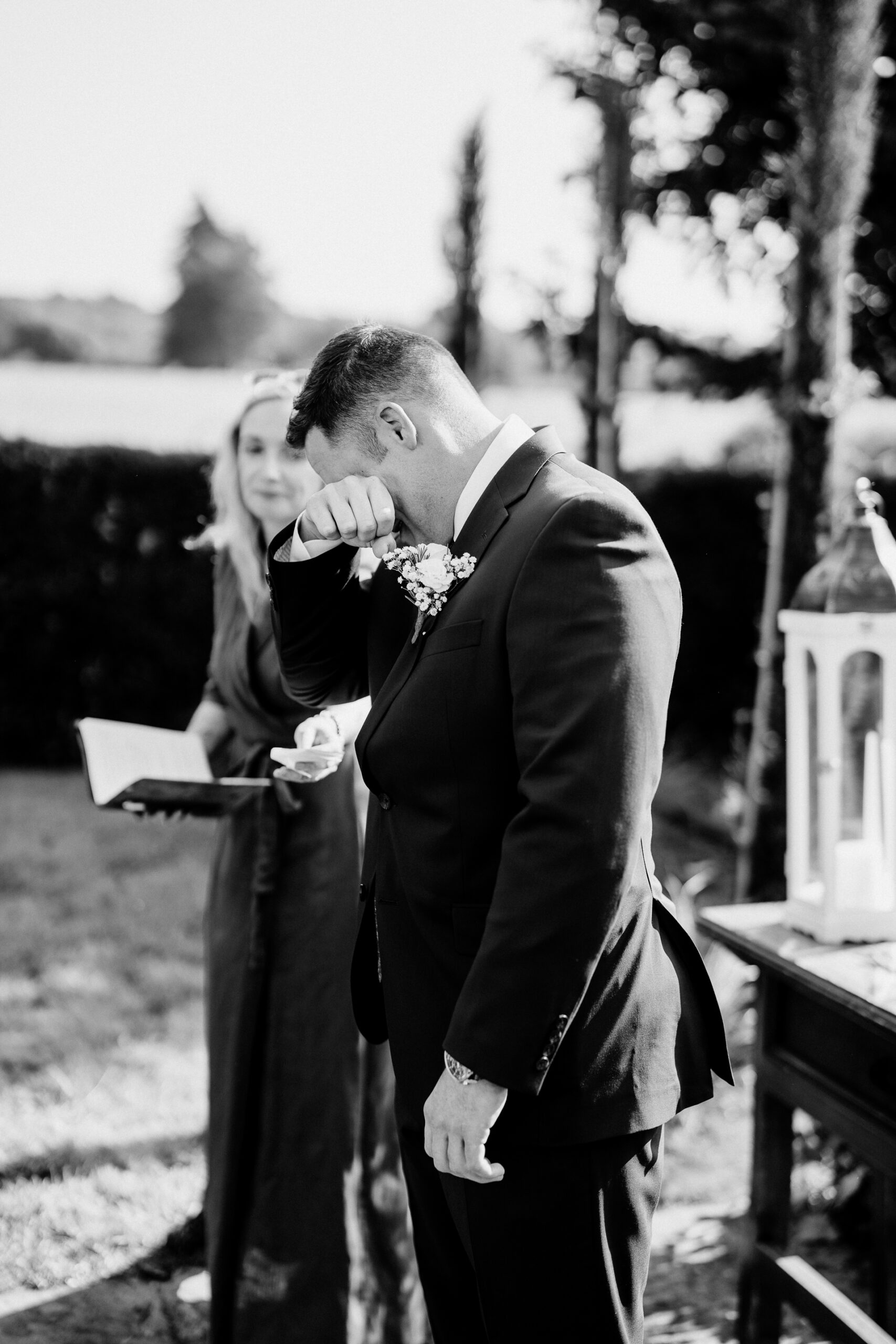 A man in a suit and tie kissing a woman in a dress