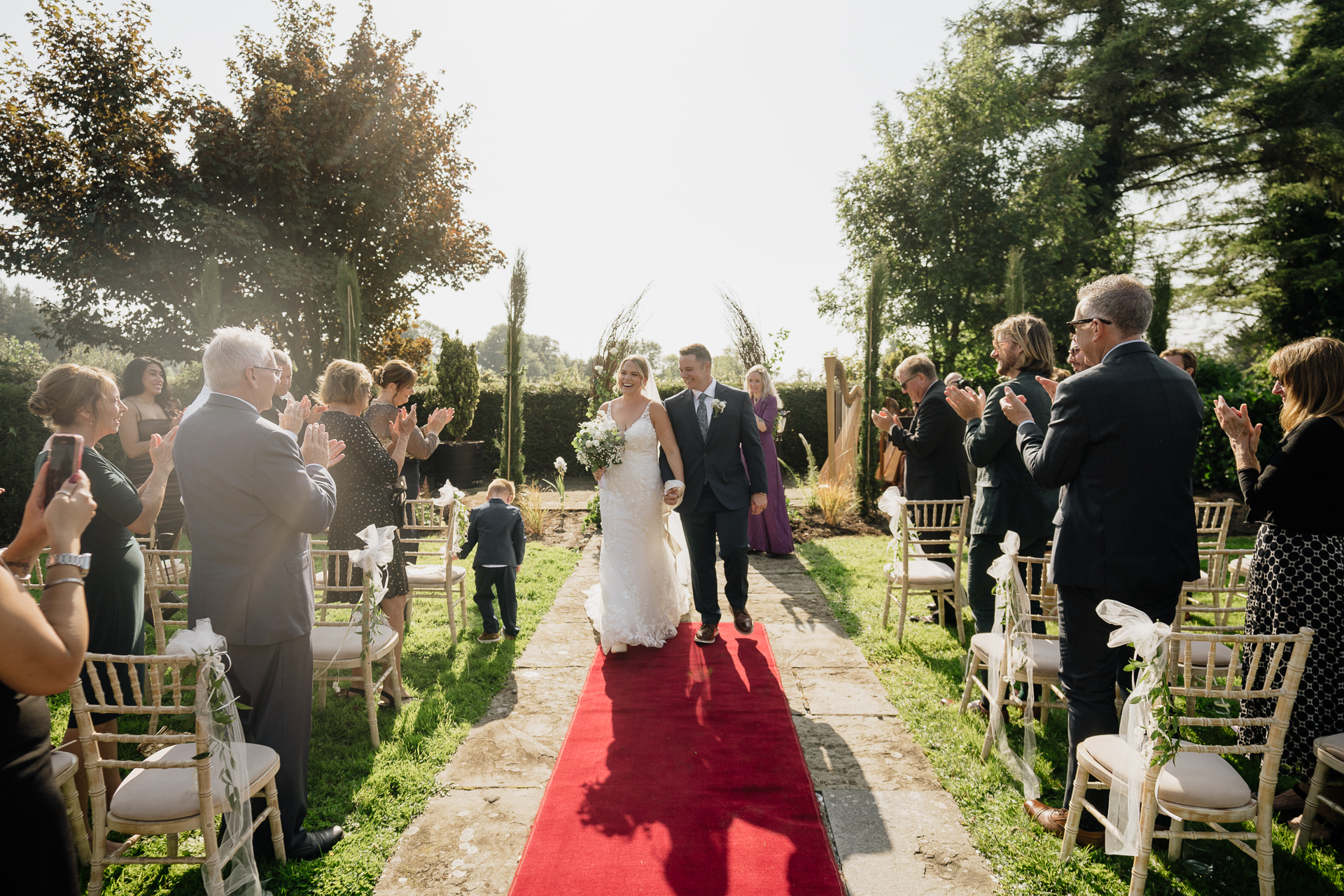 A man and woman walking down a red carpet in a wedding