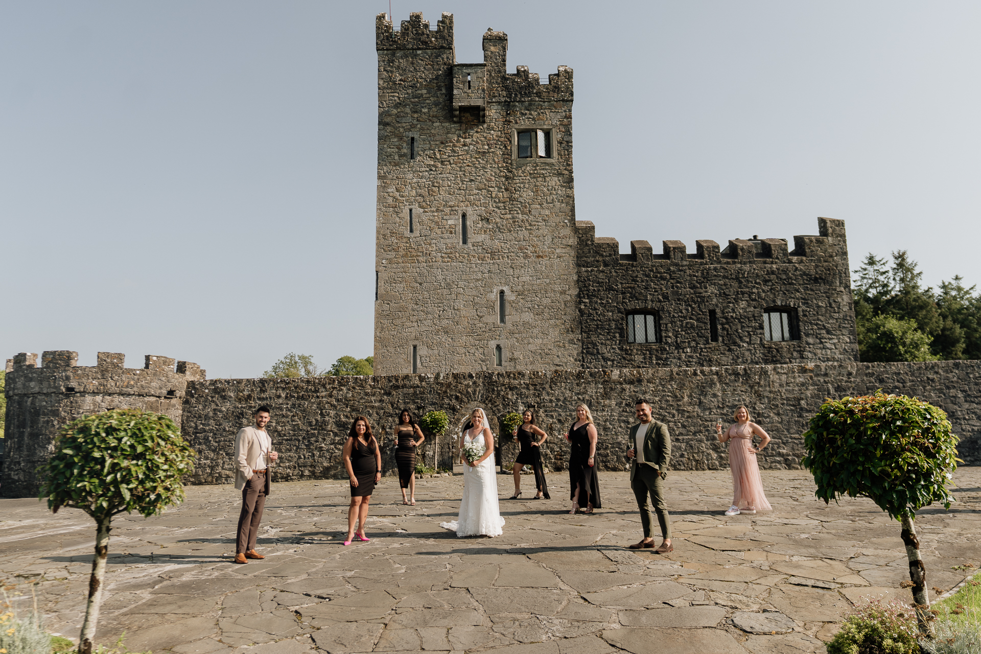 A group of people outside a castle