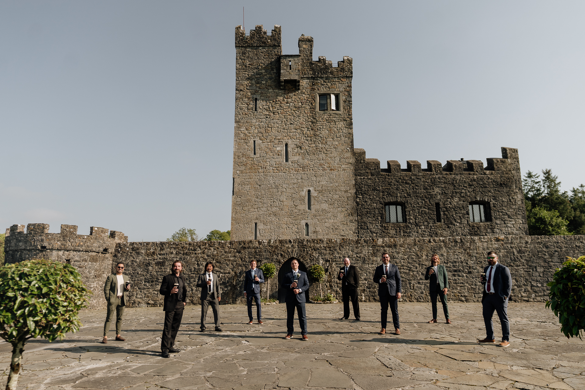 A group of people standing in front of a stone building