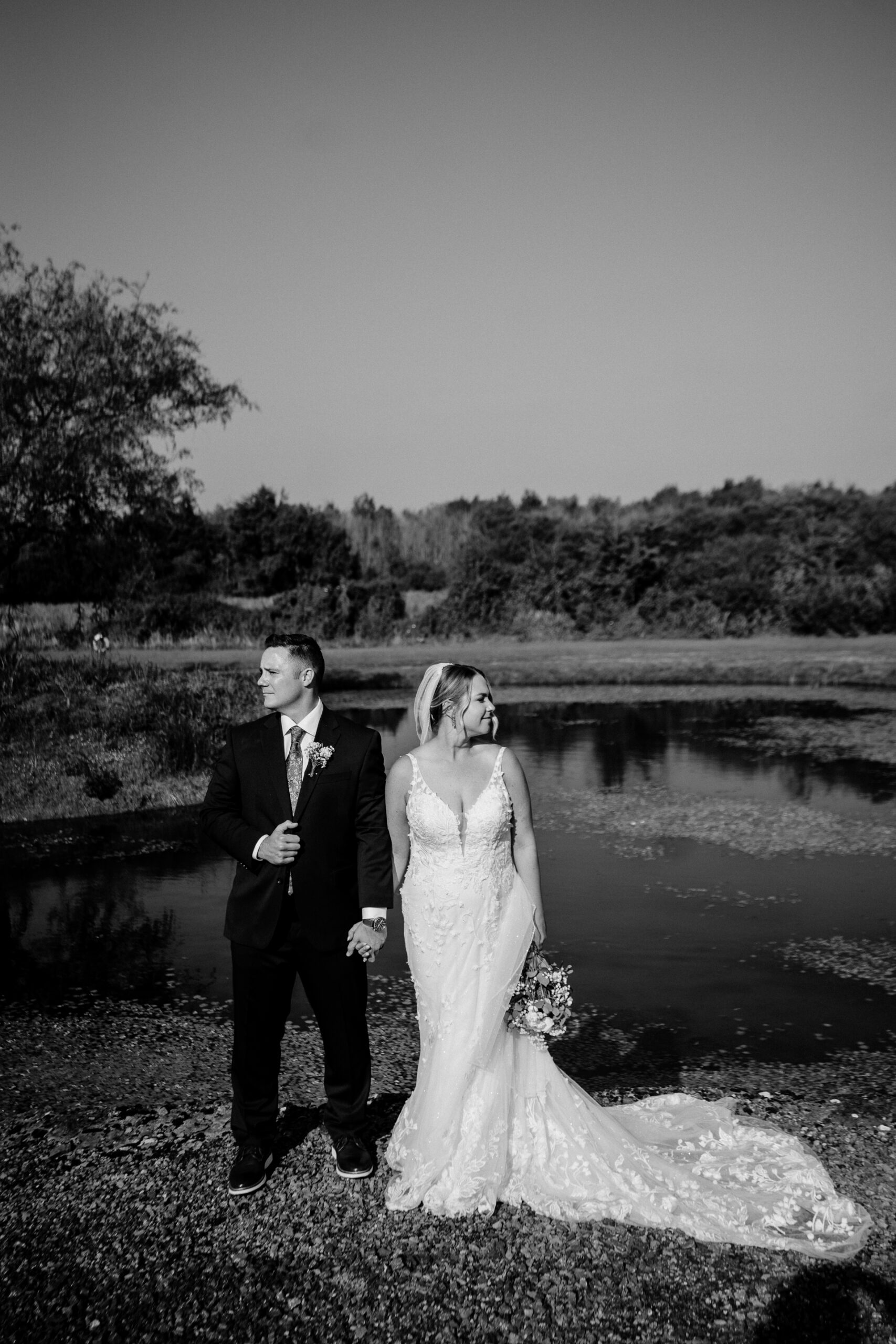 A man and woman posing for a picture next to a river