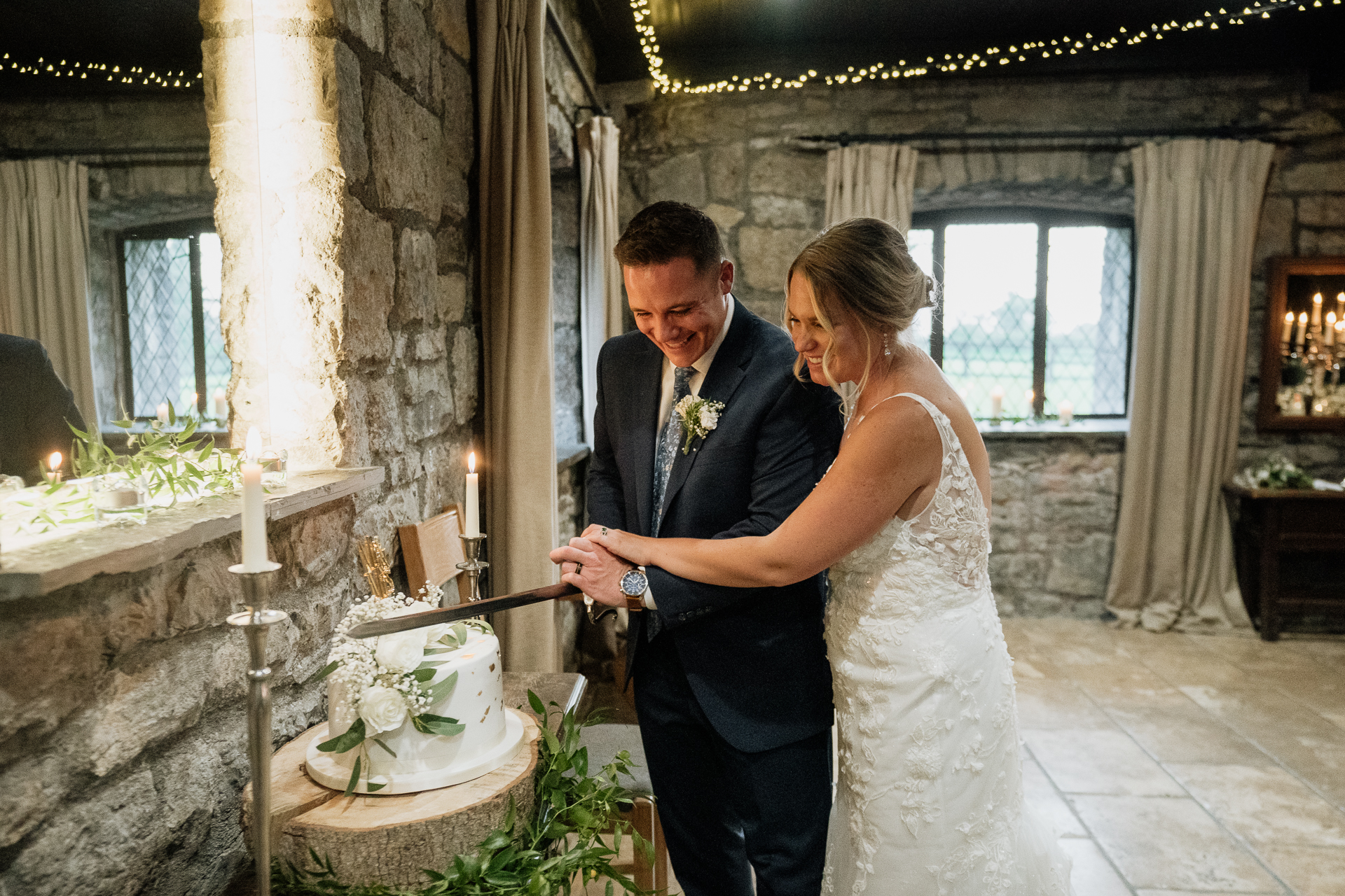 A bride and groom cutting a cake