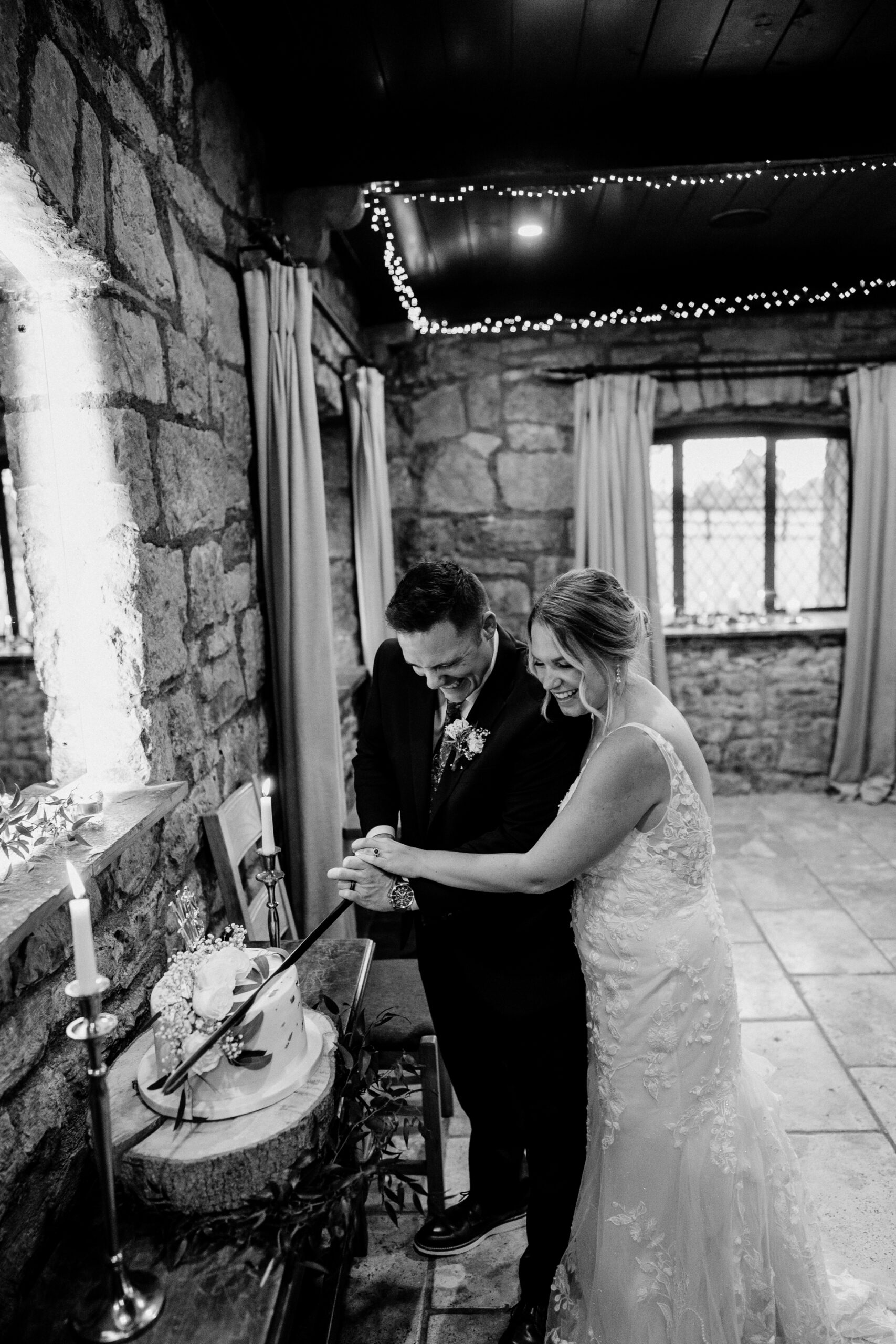 A bride and groom cutting a cake