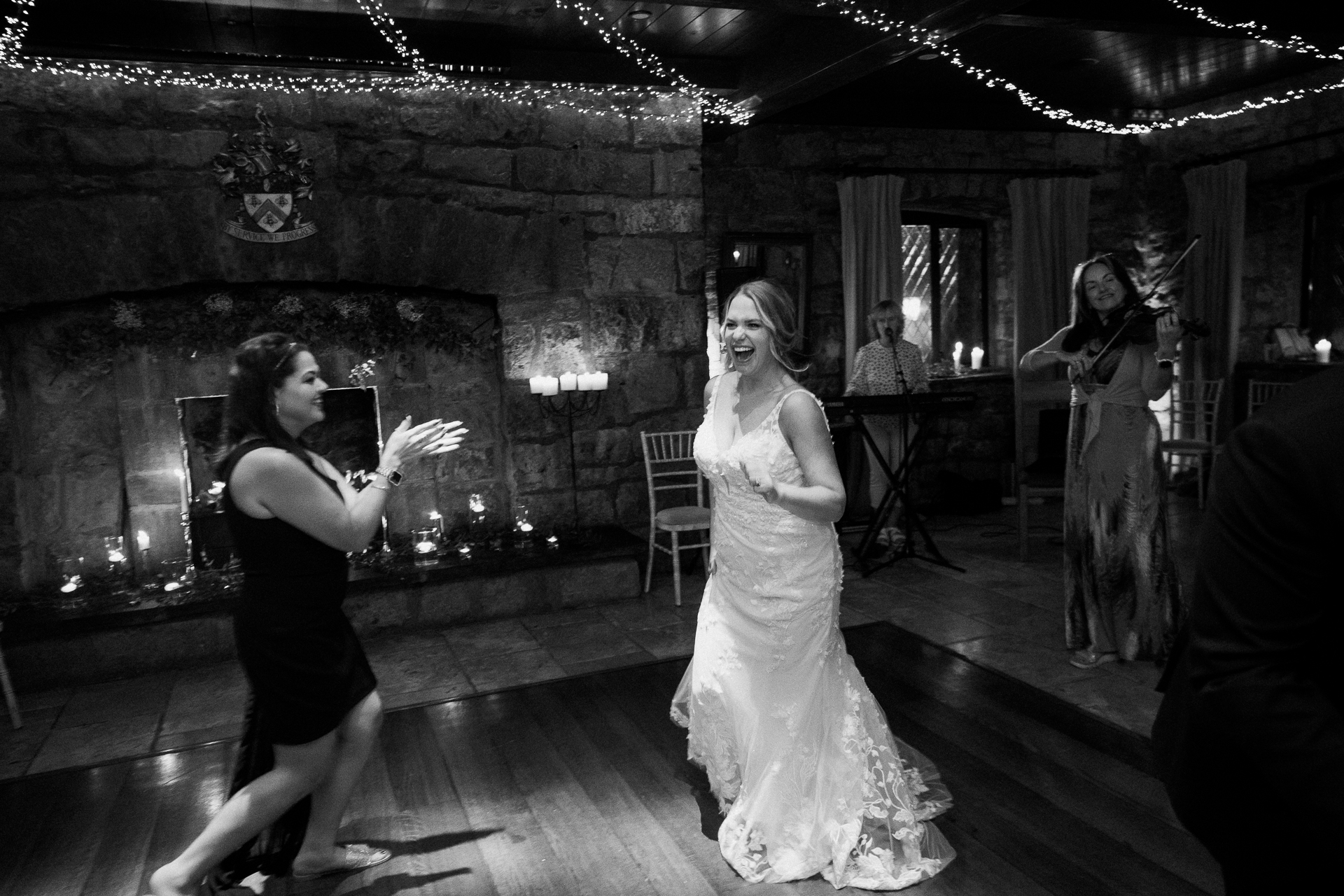 A woman in a white dress dancing with a man in a tuxedo