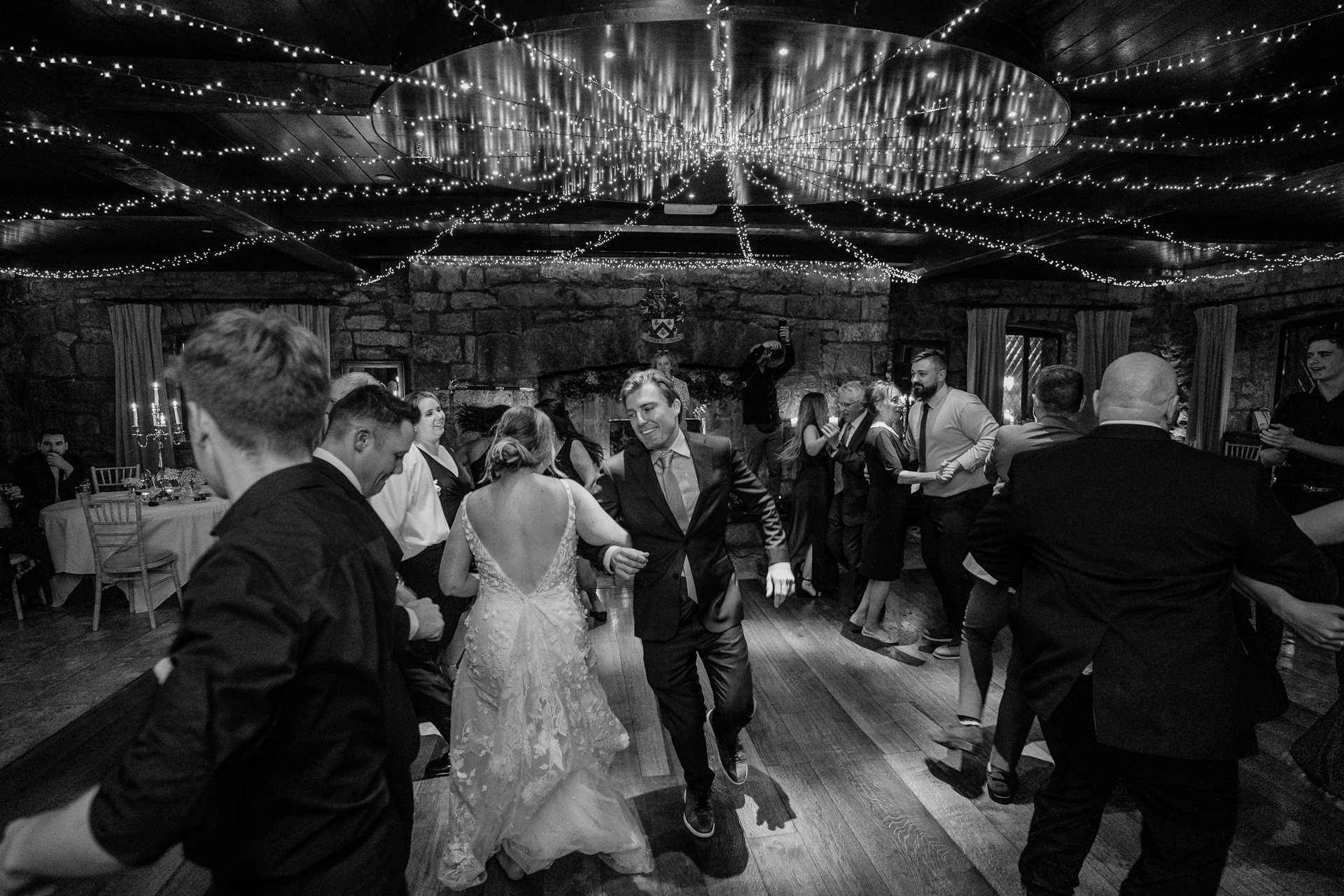 A wedding party dancing in a room