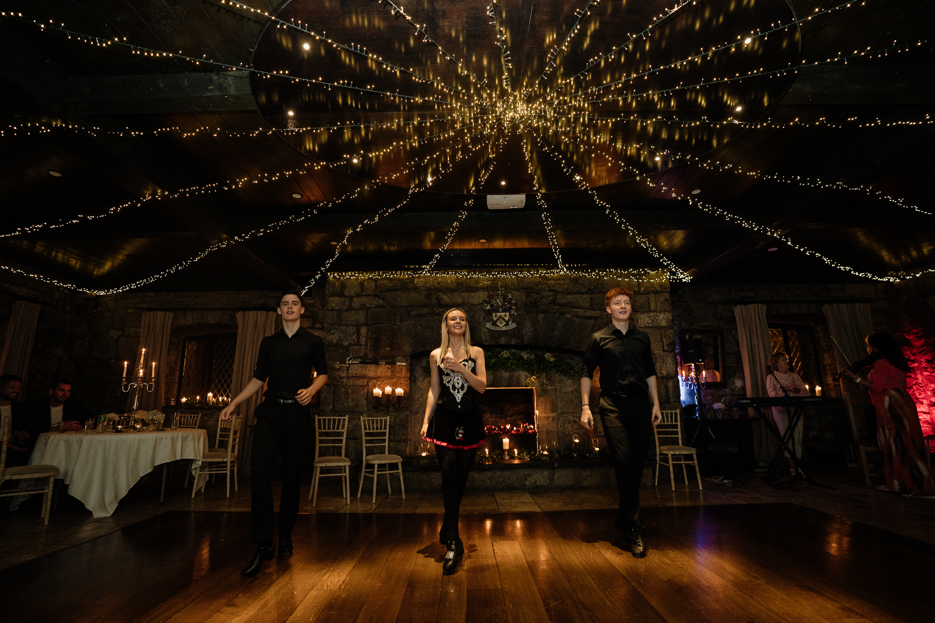 A group of people dancing on a stage with lights