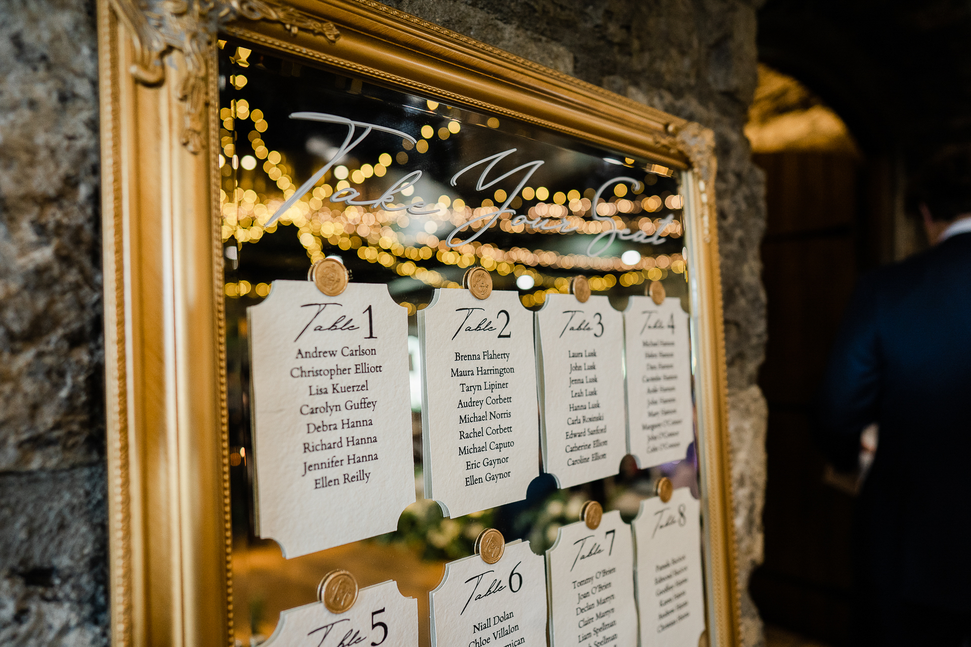 A gold framed sign with a gold and silver star and a gold chain