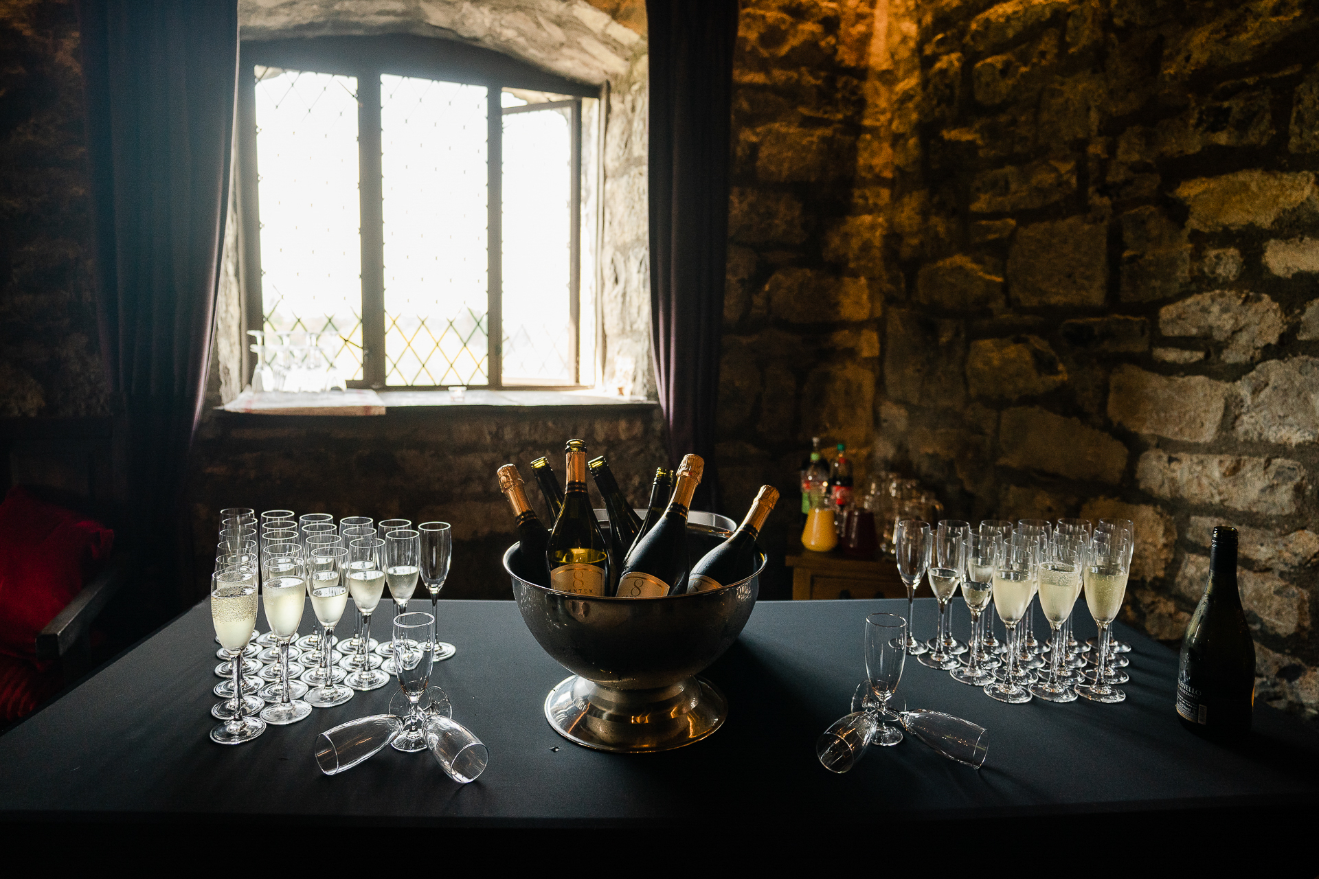 A table with wine glasses and bottles