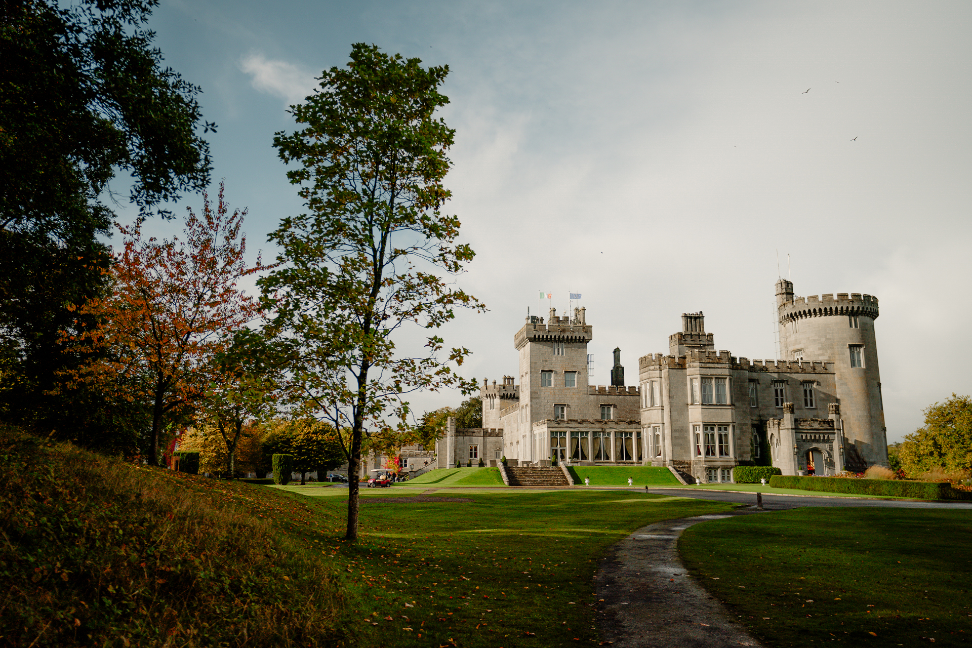 A large building with a lawn and trees in front of it