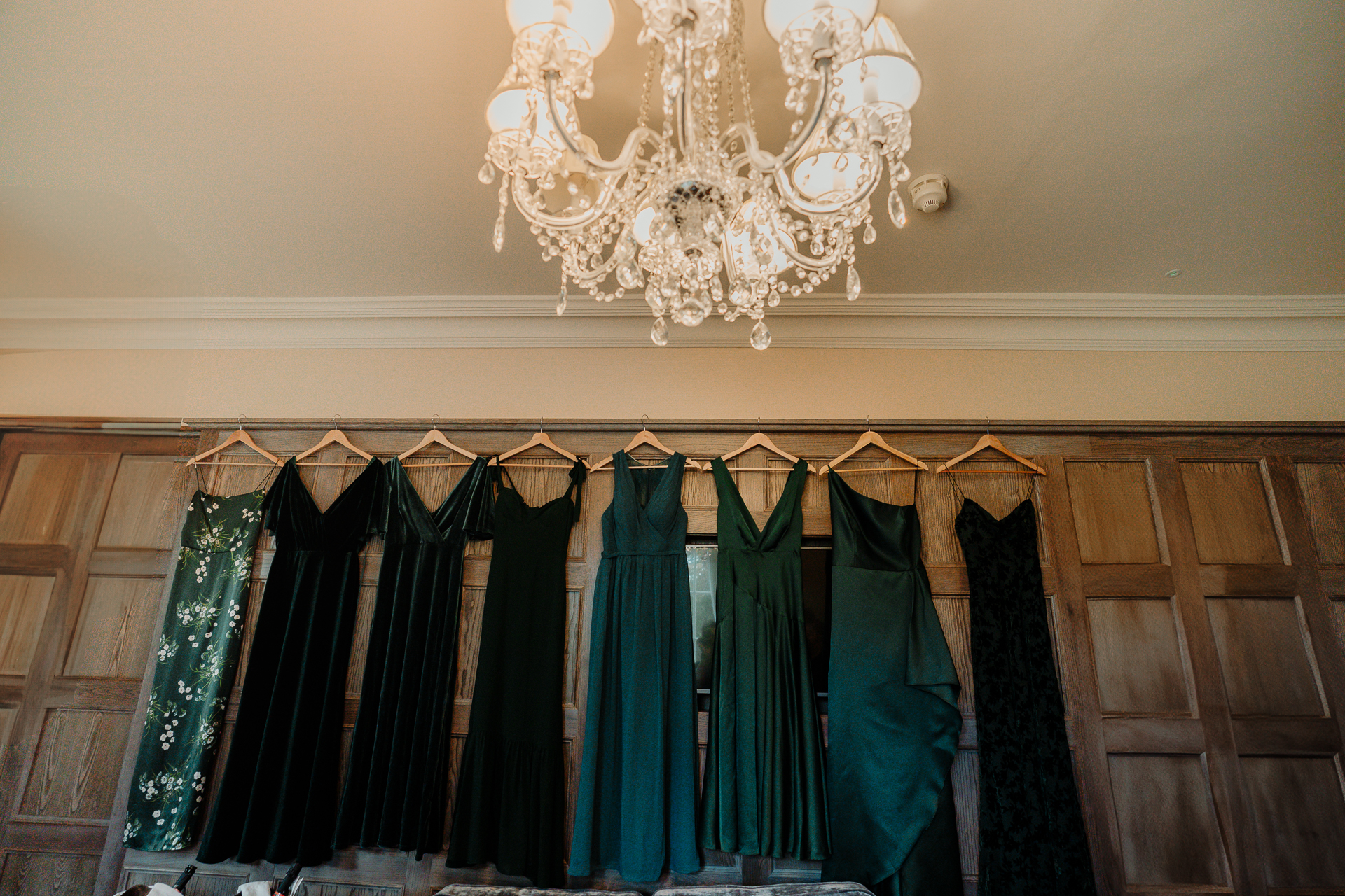 A row of dresses on a wall