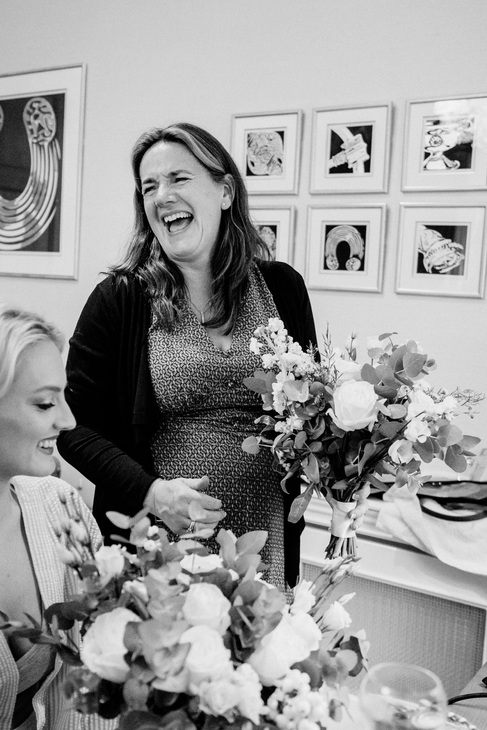 A woman smiling next to a bouquet of flowers