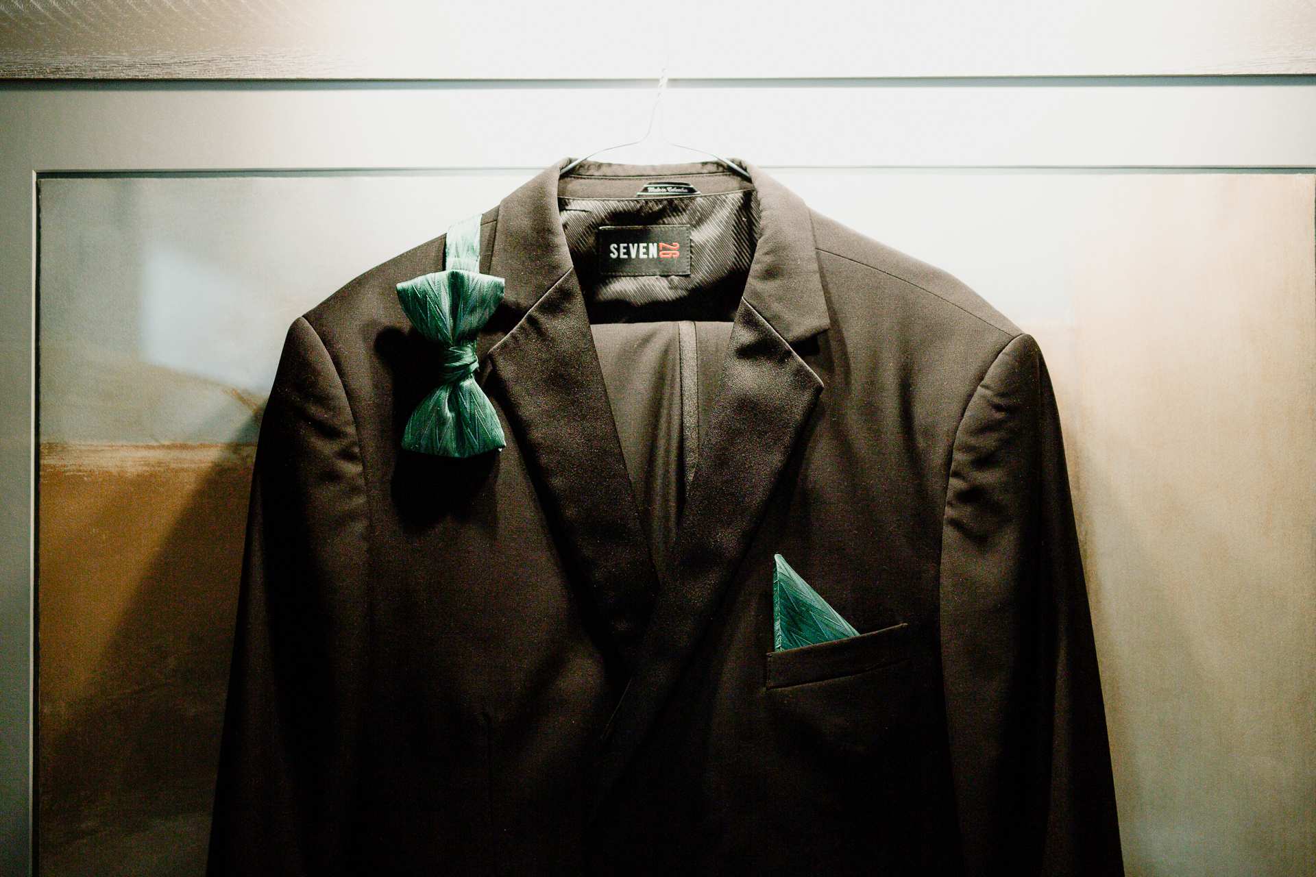 A brown jacket with a green bow