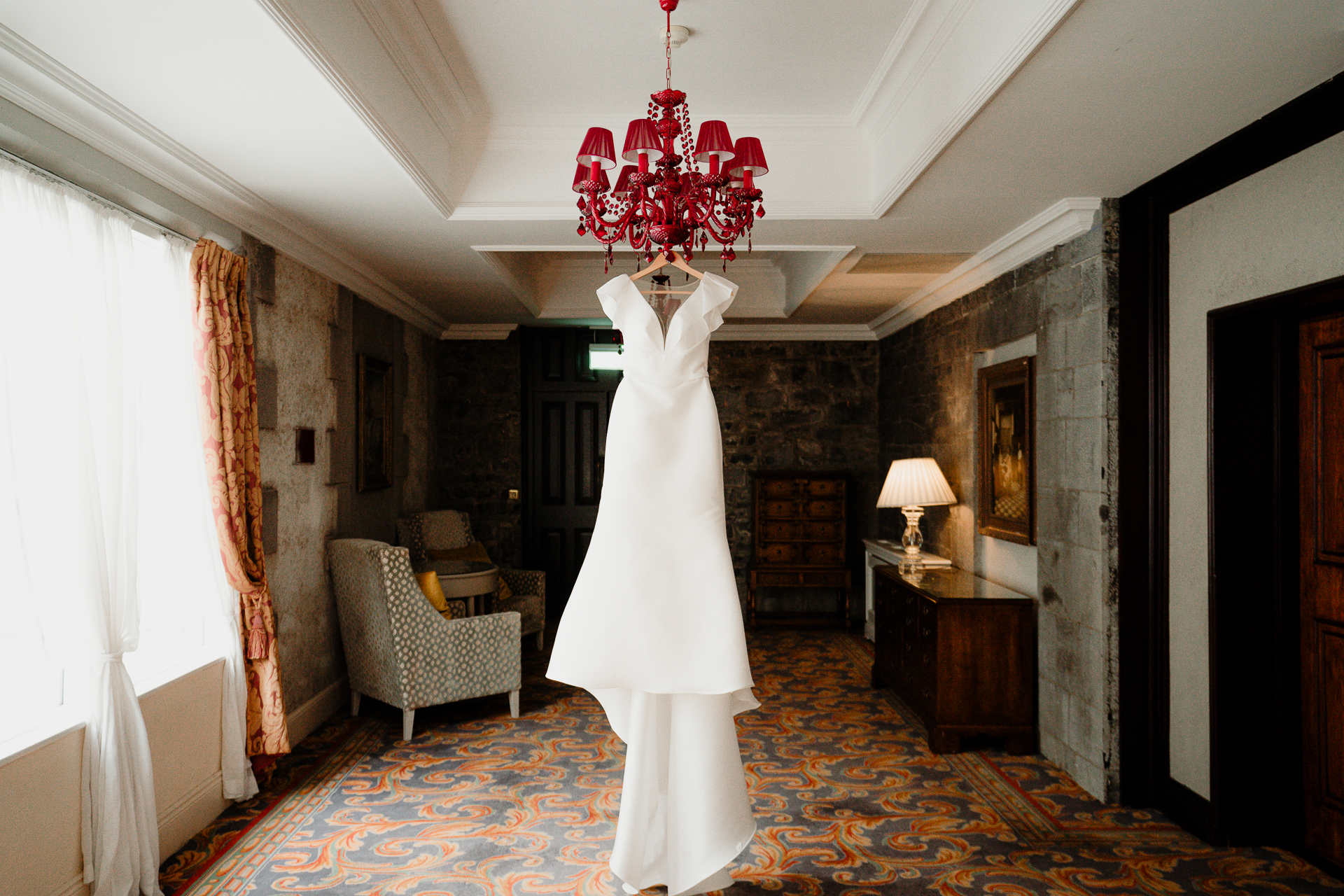 A room with a chandelier and a chair