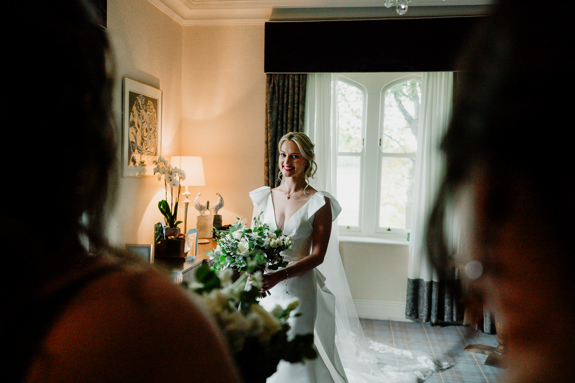 A person in a white dress holding a bouquet of flowers