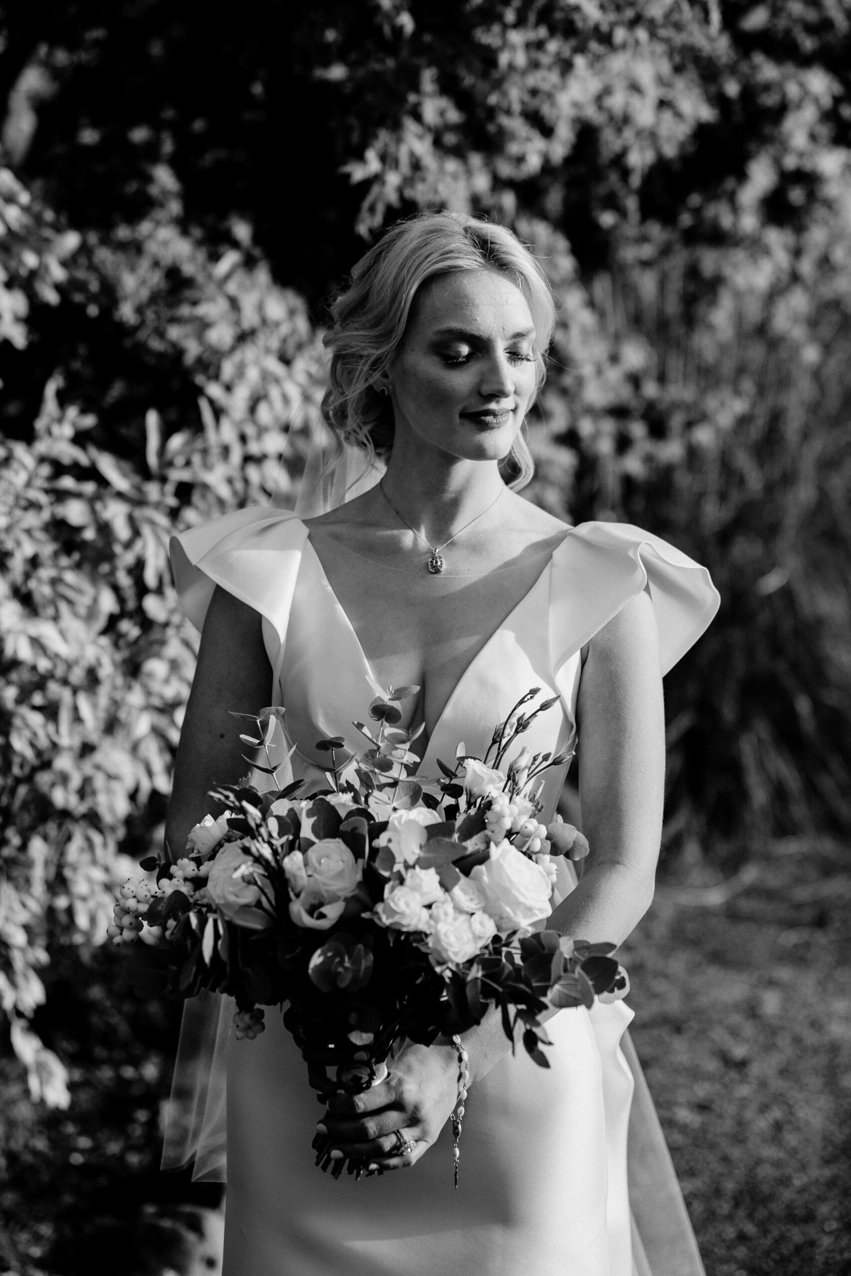 A person in a dress holding flowers